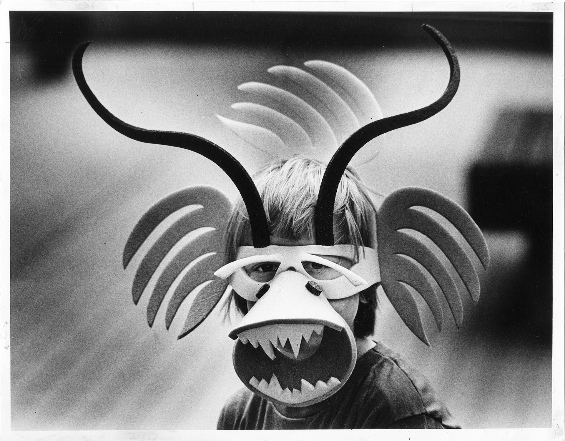 Image of Child wearing mask at Bumbershoot, Seattle, September 4, 1981