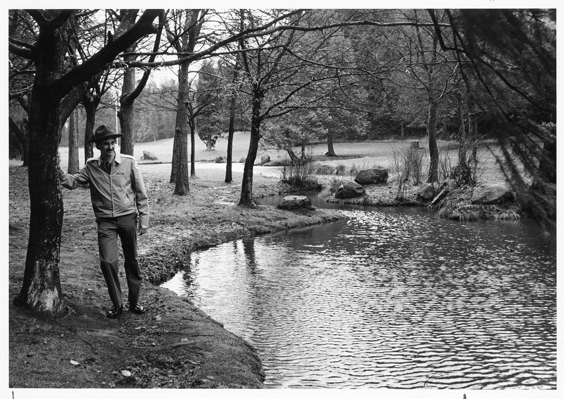 Image of Ranger standing at Polliwog Pond, Camp Long, Seattle, March 7, 1985