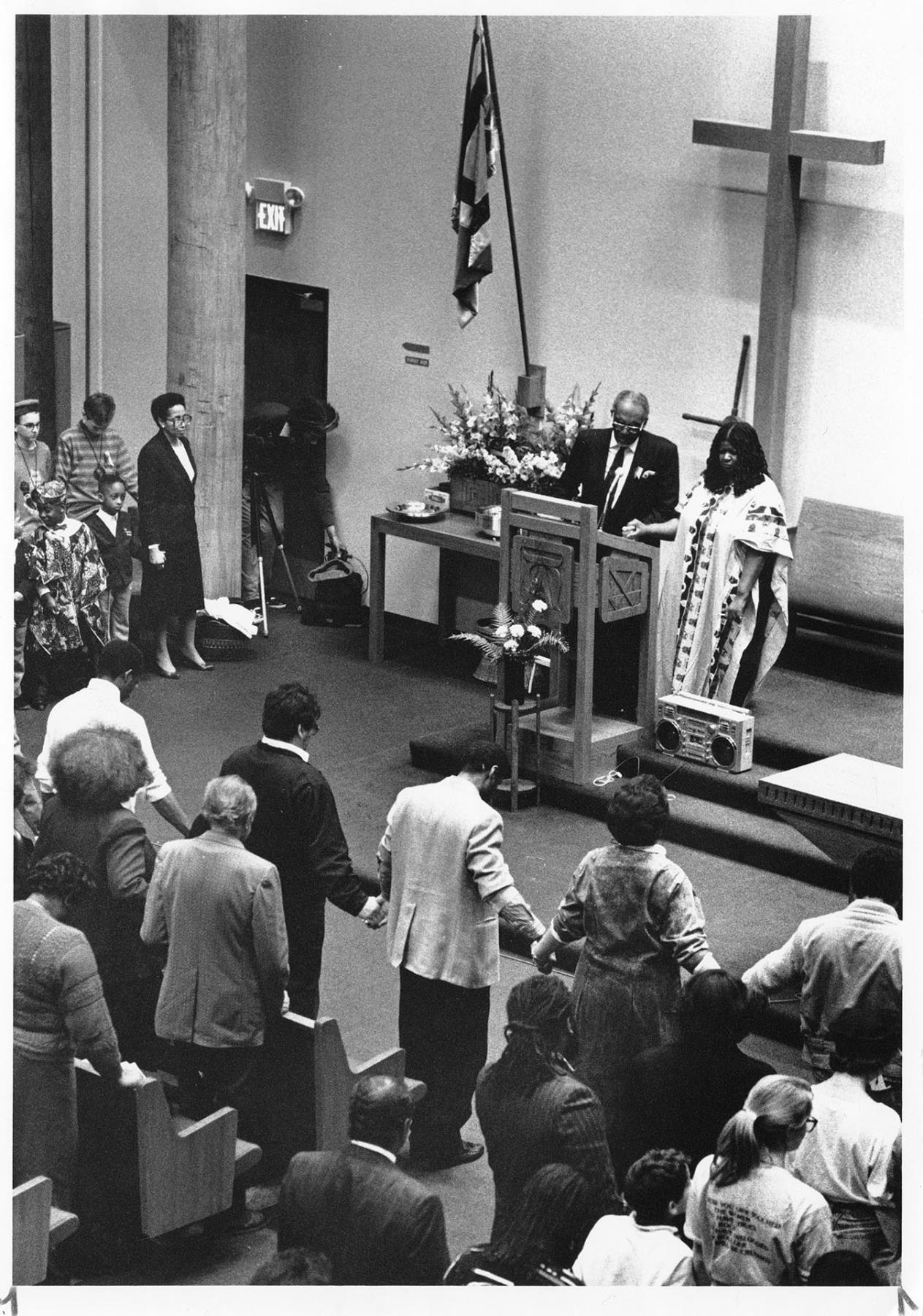 Image of Pastor Samuel McKinney and Maryamu Eltayeb leading prayer at Mount Zion Baptist Church, Seattle, February 11, 1990