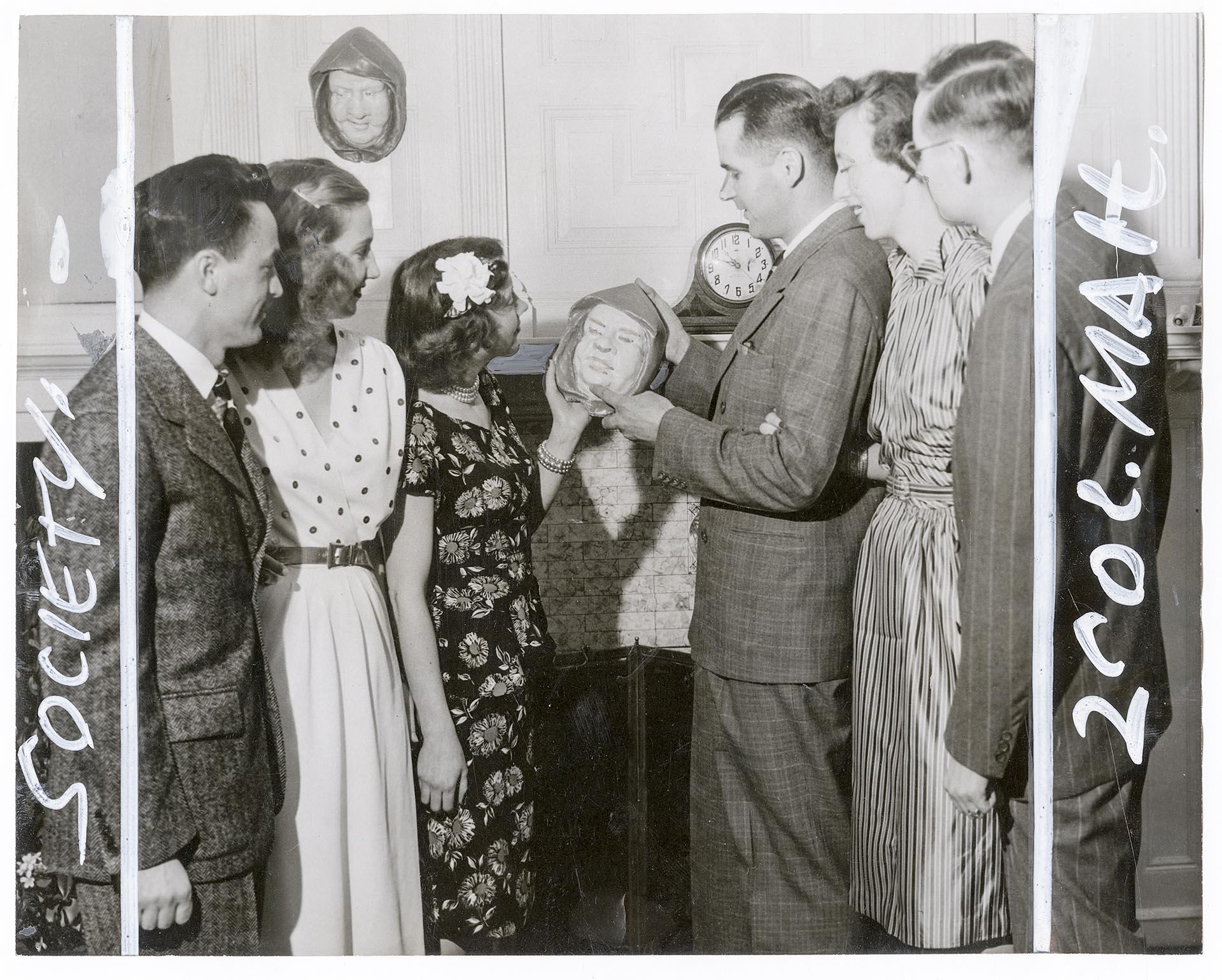 Image of Members and guests examining busts at Monks Club, Seattle, April 27, 1946