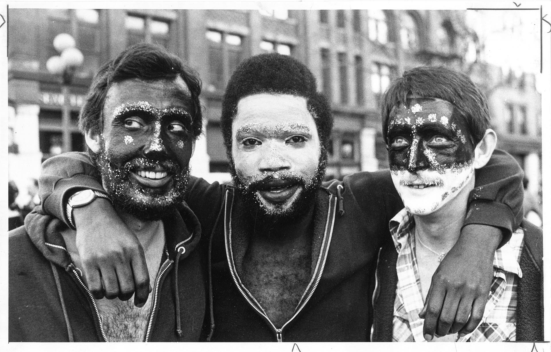 Image of Three men with painted faces at Fat Tuesday celebration, Seattle, February 19, 1977