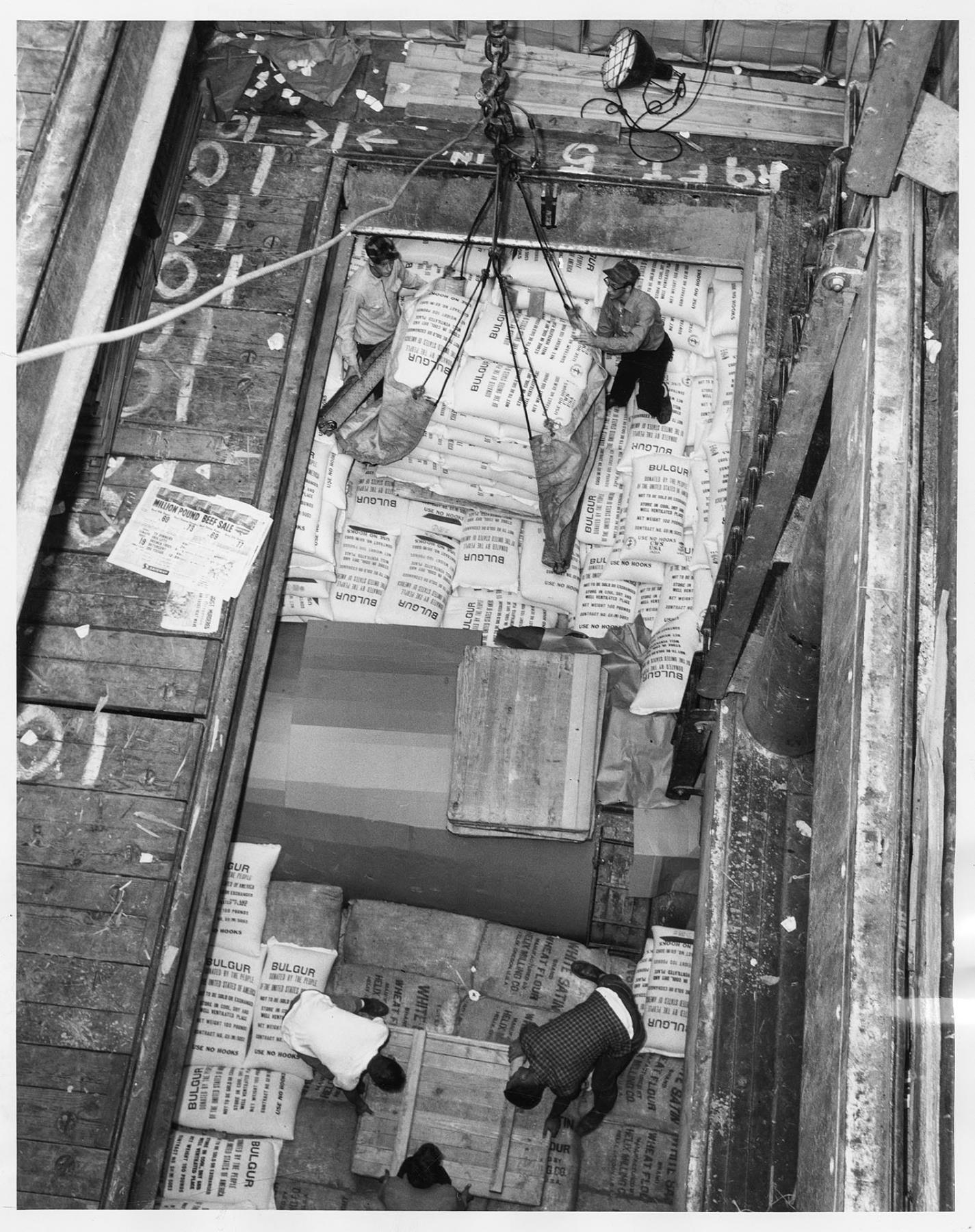 Image of Employees loading bags of bulgur at Fisher Flouring Mills, Seattle, July 24, 1961