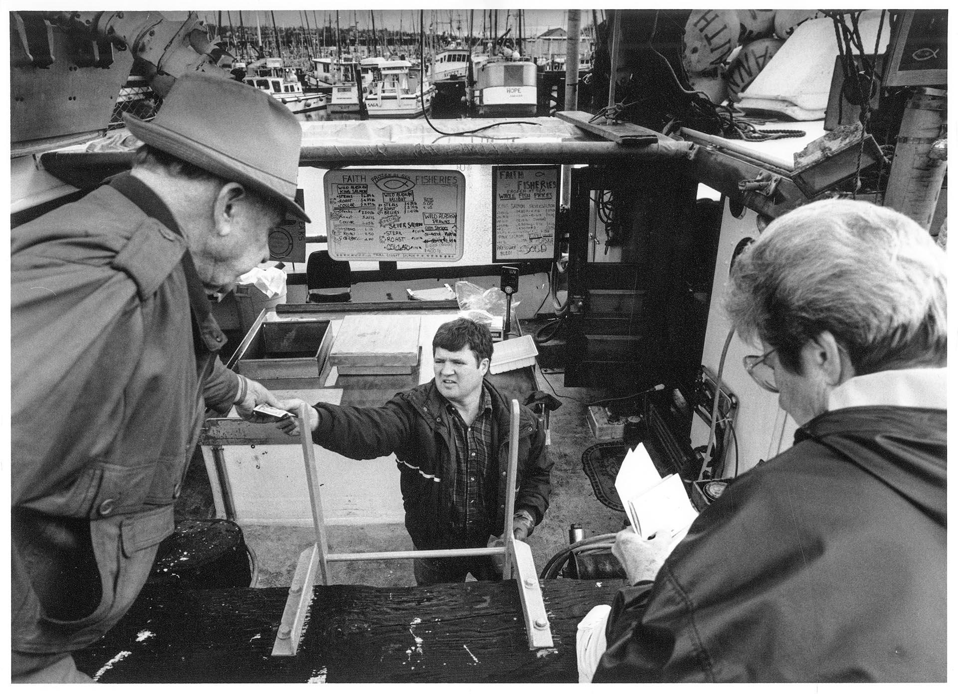 Image of James Guilmet selling fish at Fishermen's Terminal, Seattle, January 30, 1992