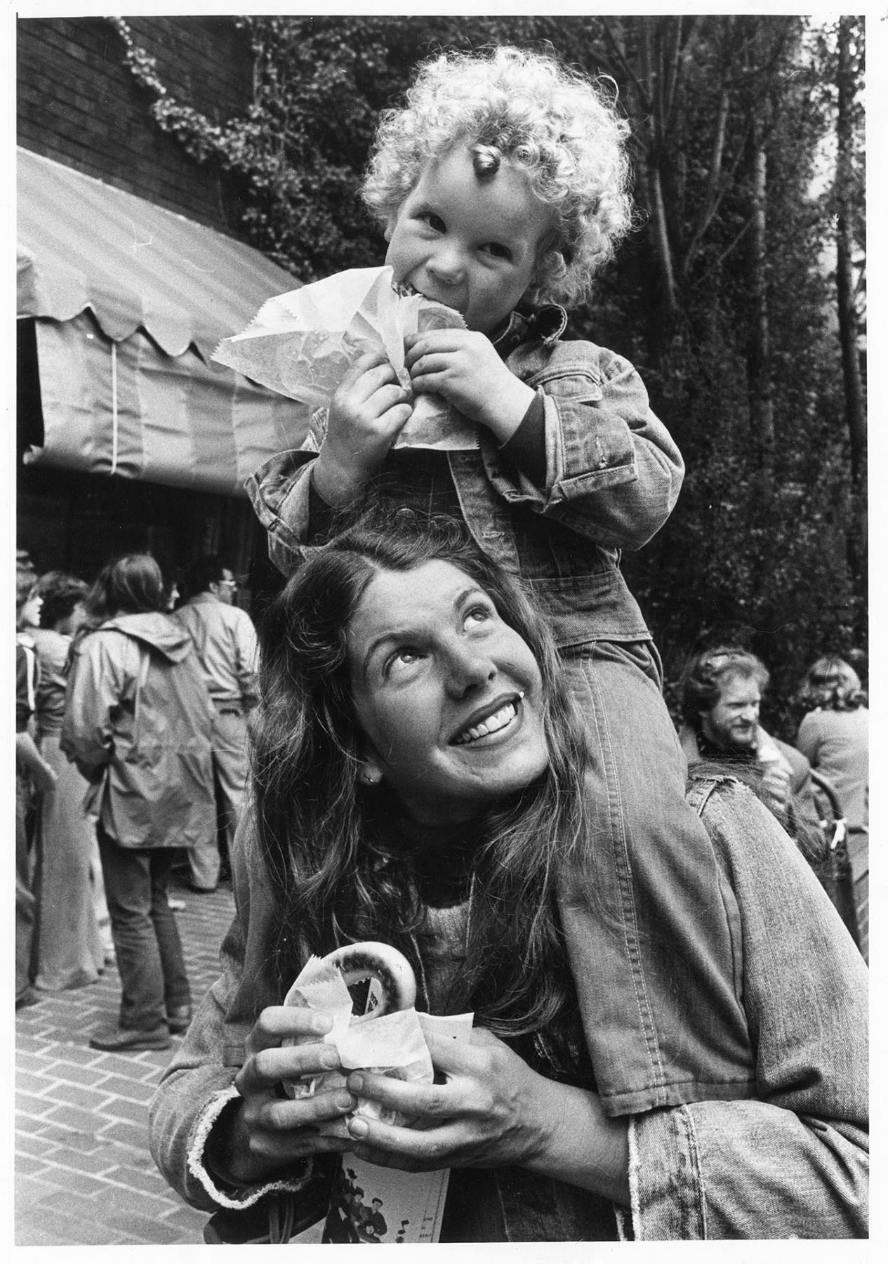 Image of Child and mother eating pretzels at Folklife Festival, Seattle Center, May 27, 1978