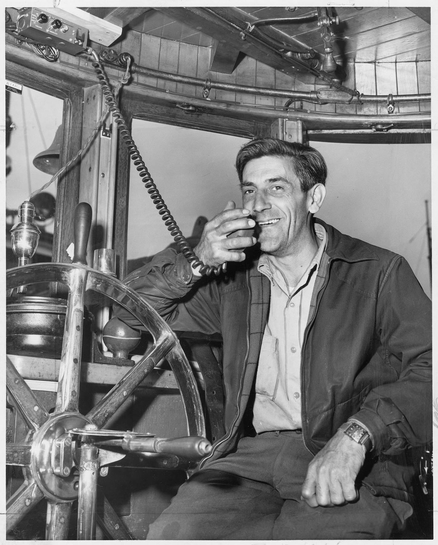 Image of Tug boat captain talking to land-based dispatchers, Seattle, June 11, 1949