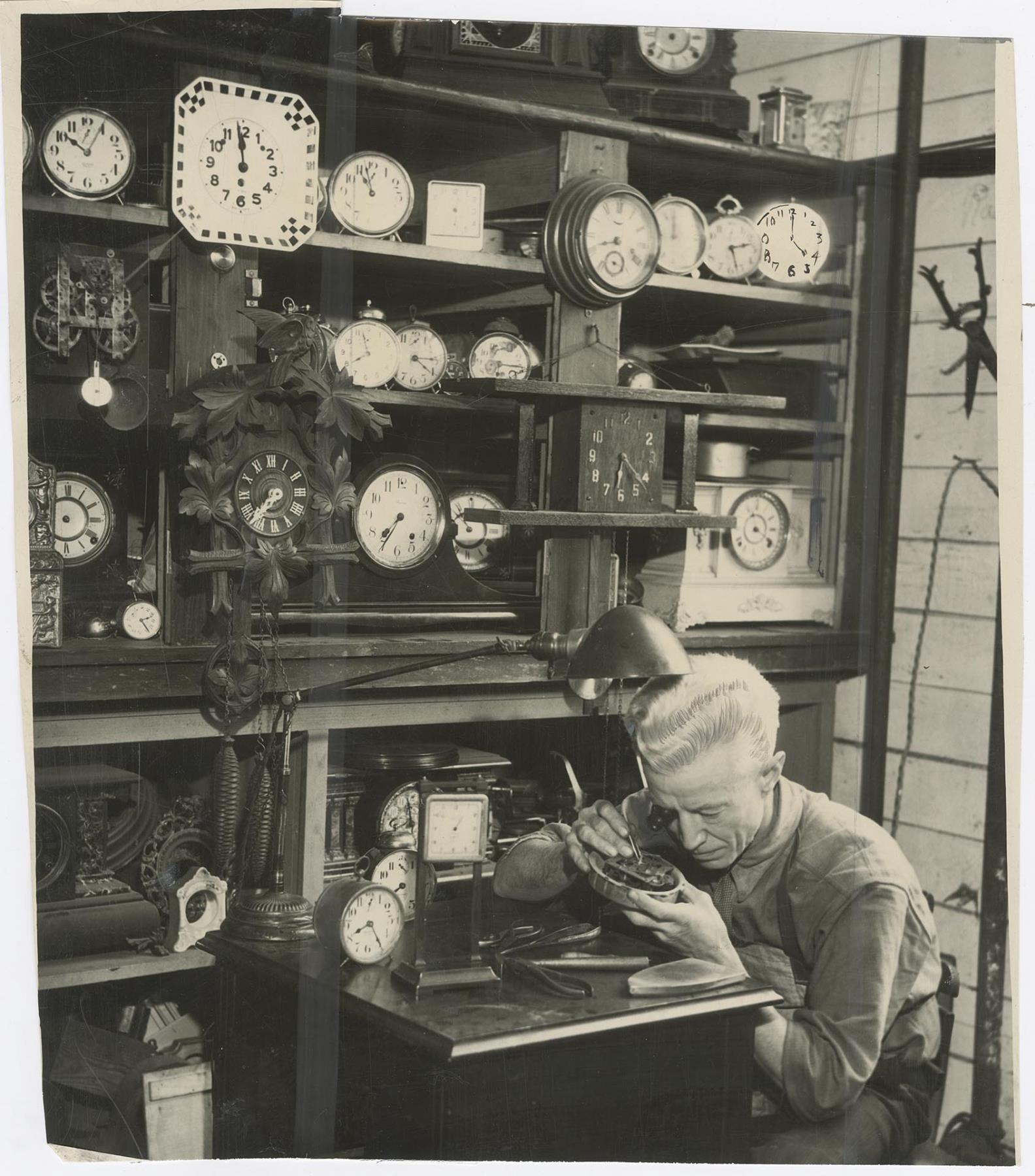Image of Clock maker repairing clocks at Goodwill, Seattle, November 19, 1933