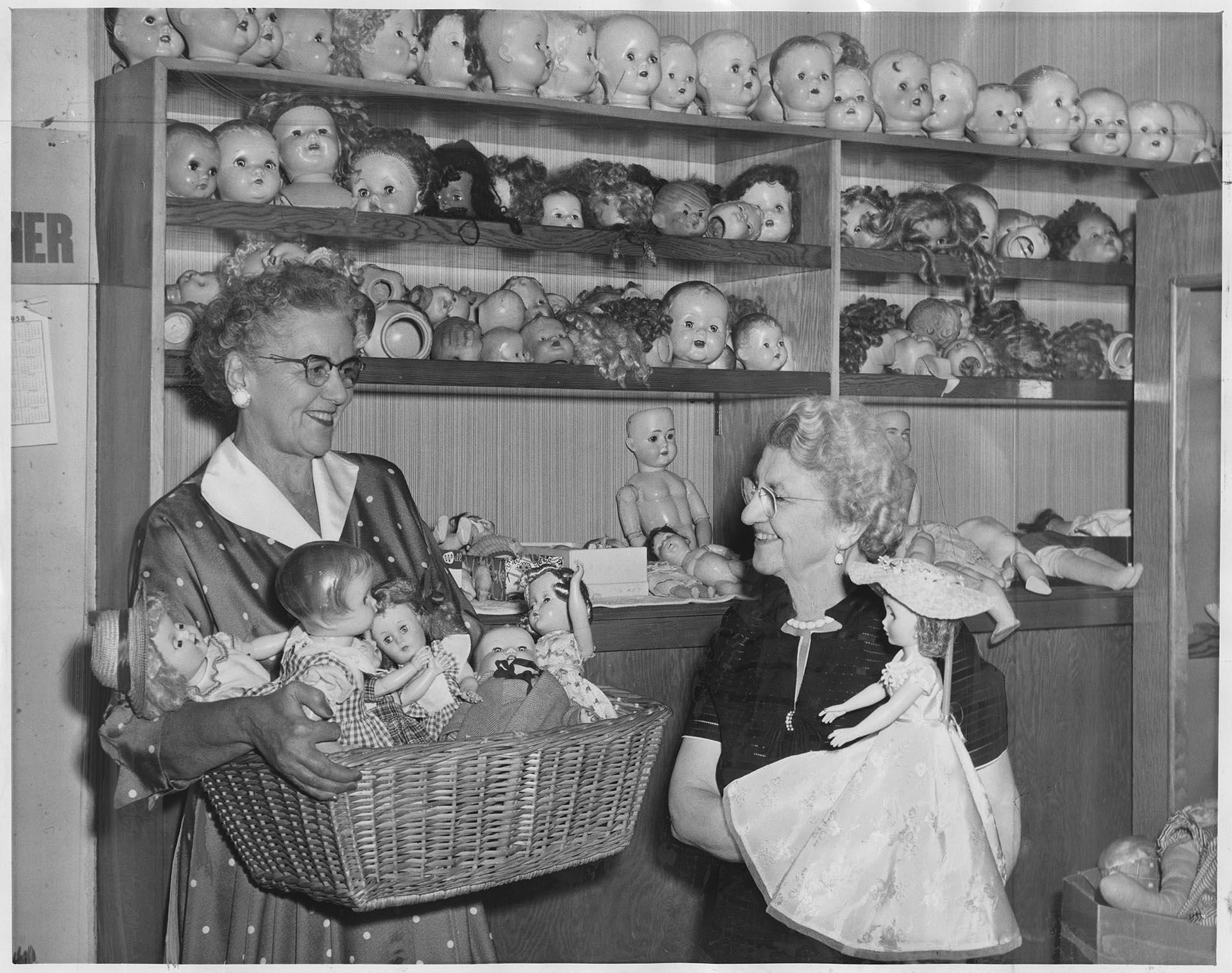 Image of Goodwill Auxiliary members displaying dolls for sale, Seattle, November 2, 1958