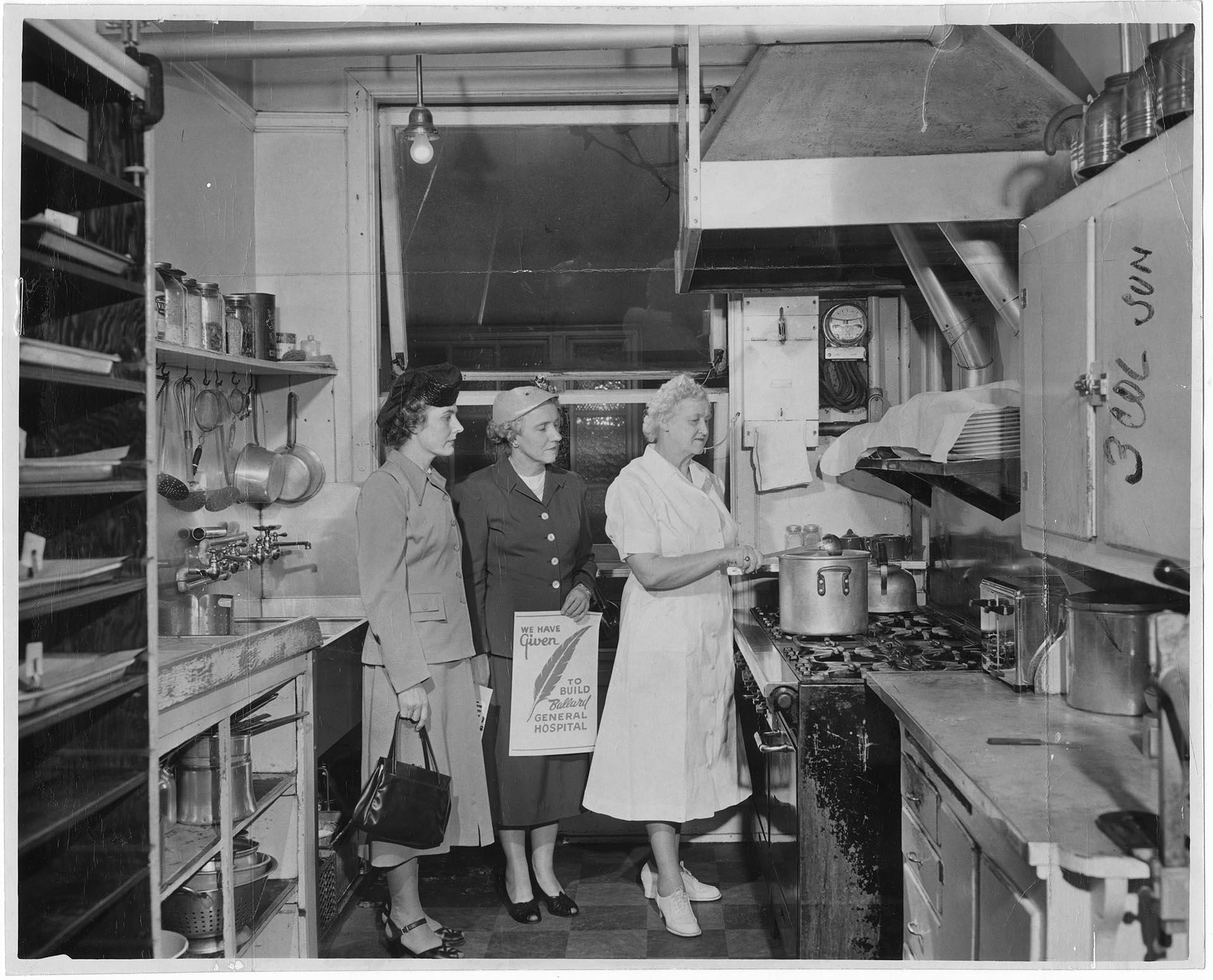Image of Visitors touring the kitchen of the old Ballard hospital, Seattle, April 20, 1952