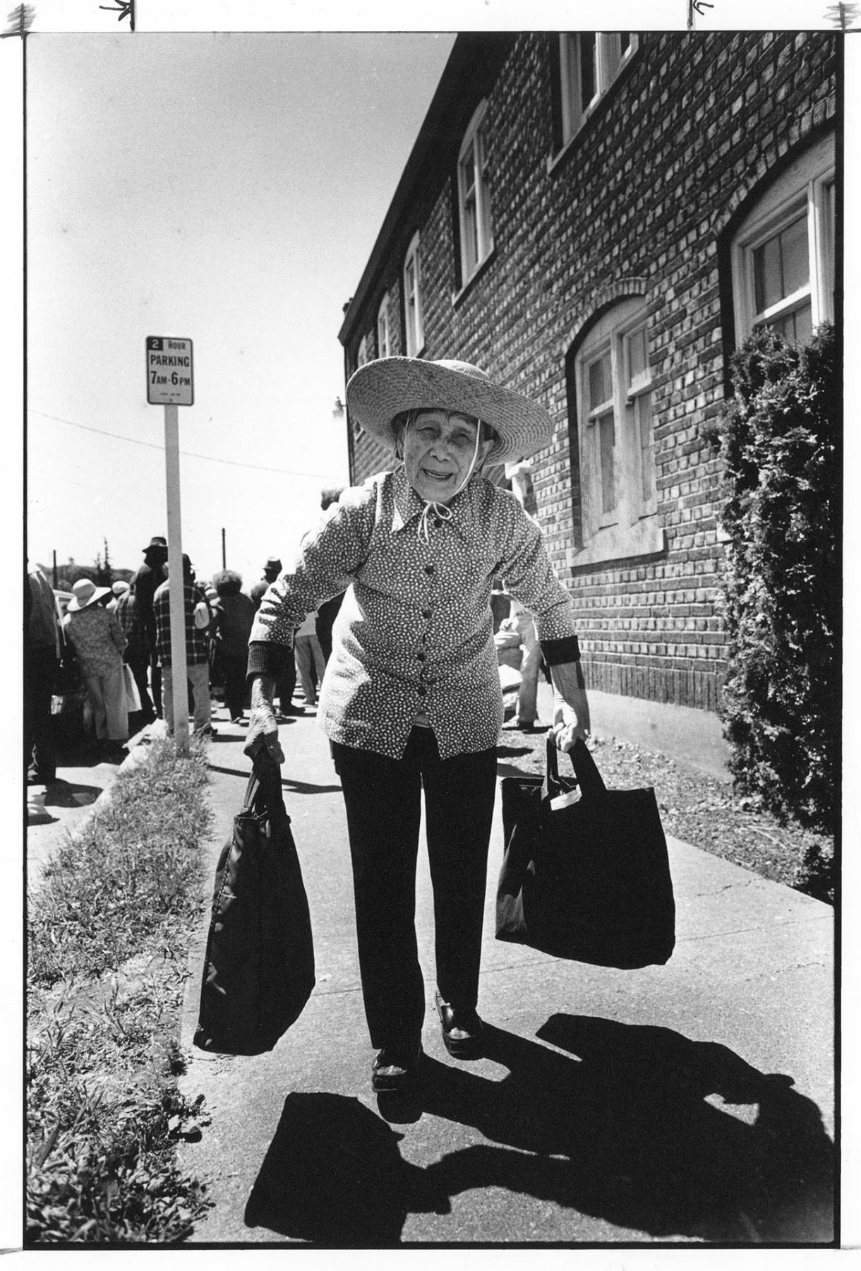 Image of Elderly Chinese woman carrying bags of groceries, Seattle, June 29, 1988