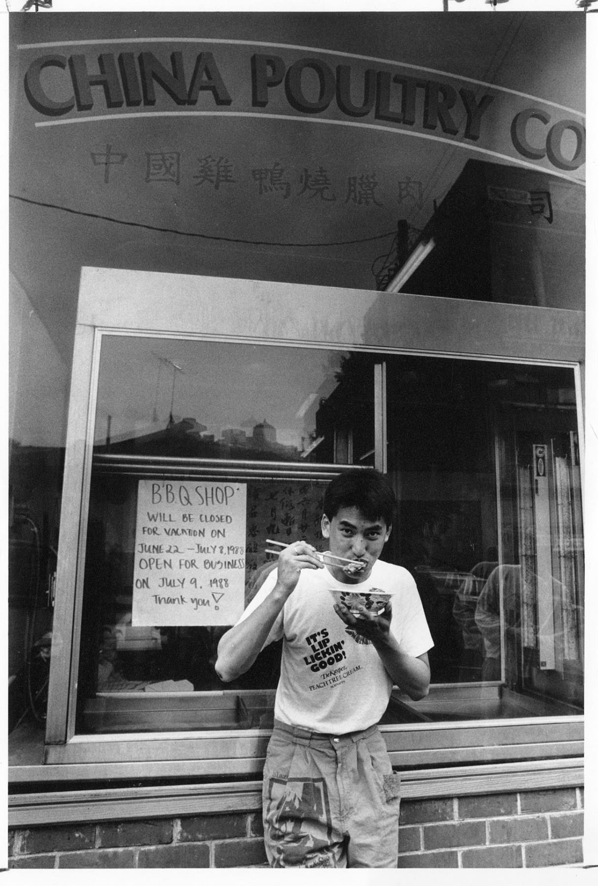 Image of Man eating Chinese BBQ, Seattle, June 29, 1988