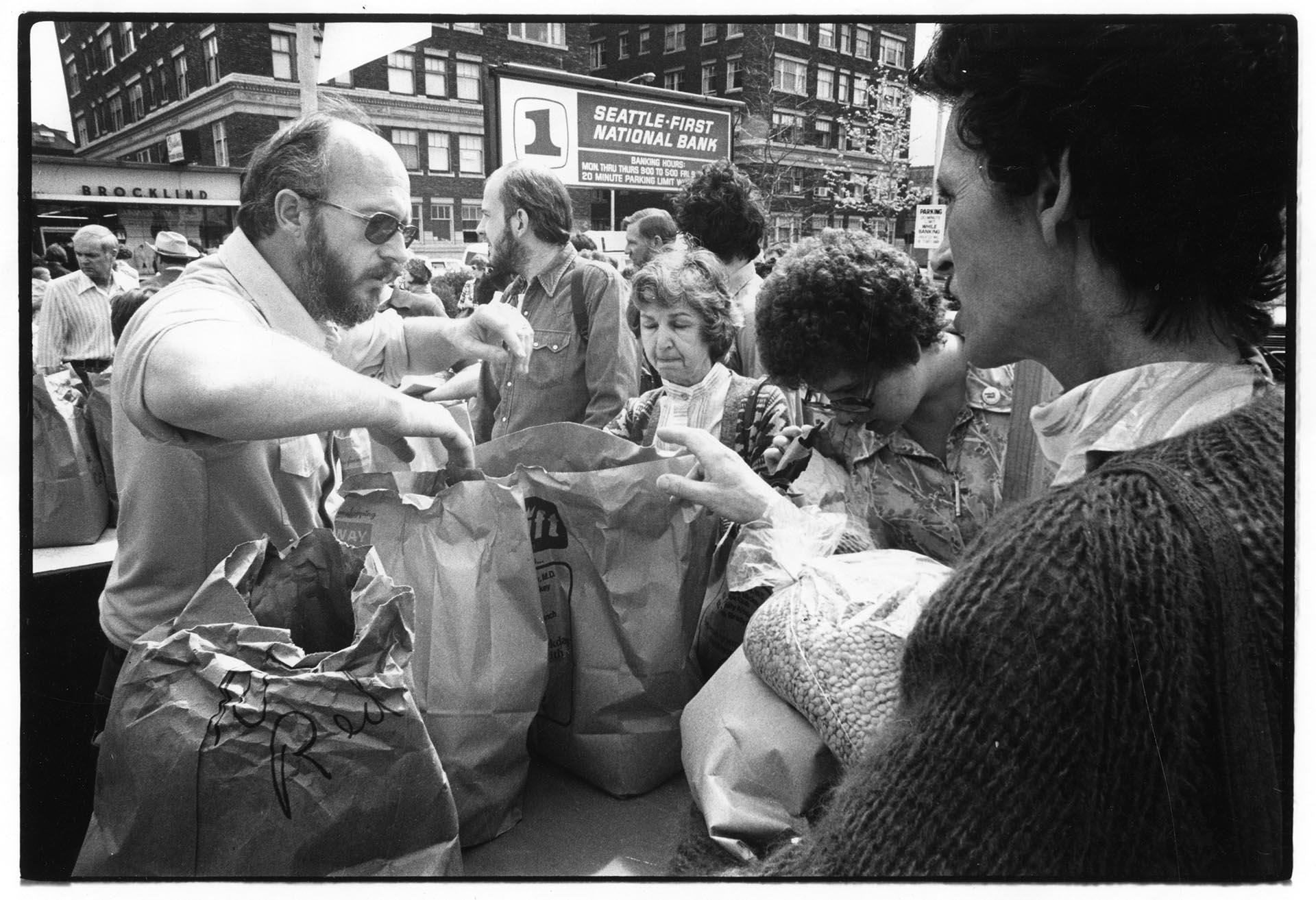 Image of J. B. McCrummen selling produce at U-District farmers market, Seattle, April 23, 1977