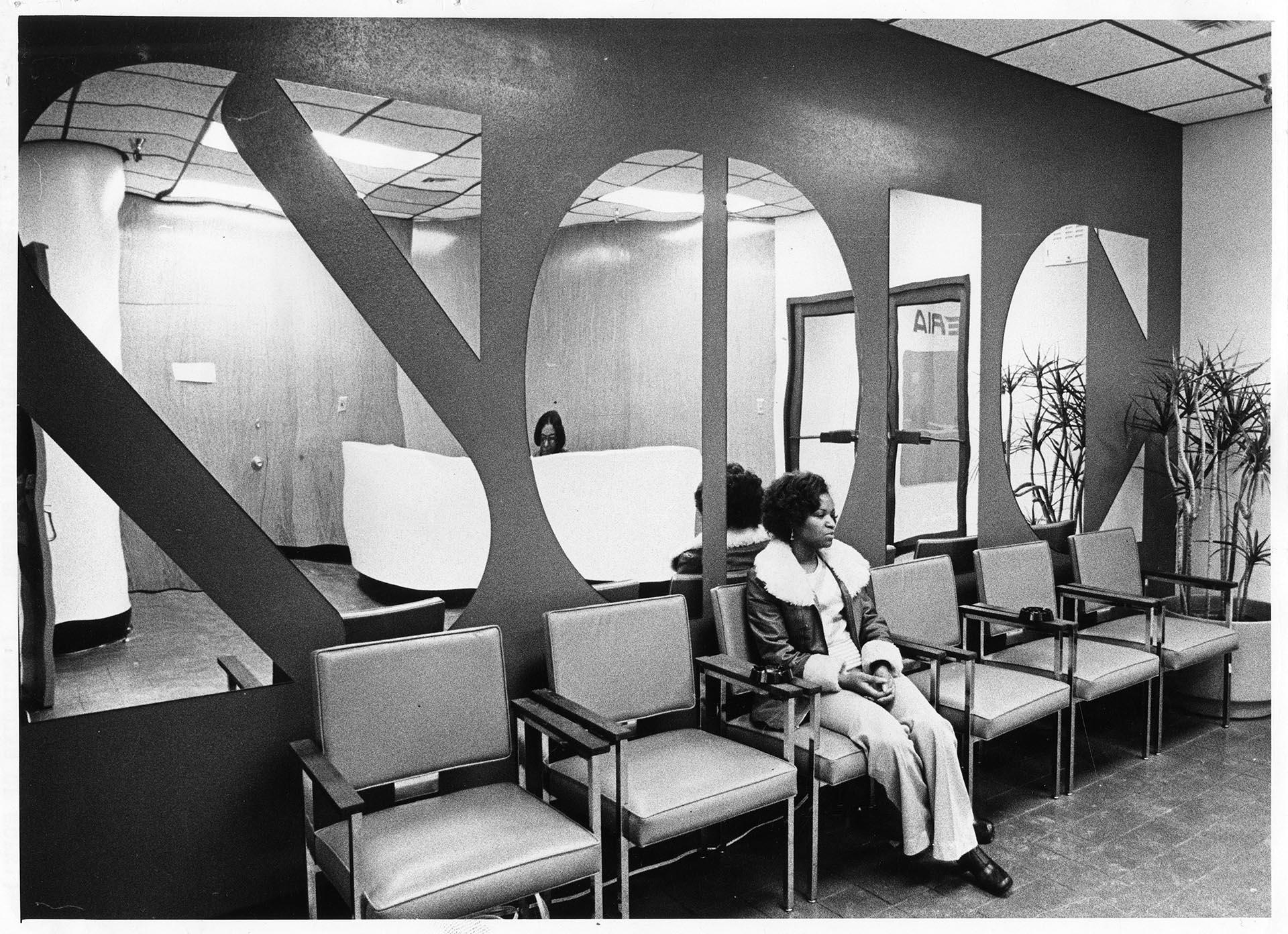 Image of Florence Donley sitting in lobby of new SOIC building, Seattle, January 17, 1975