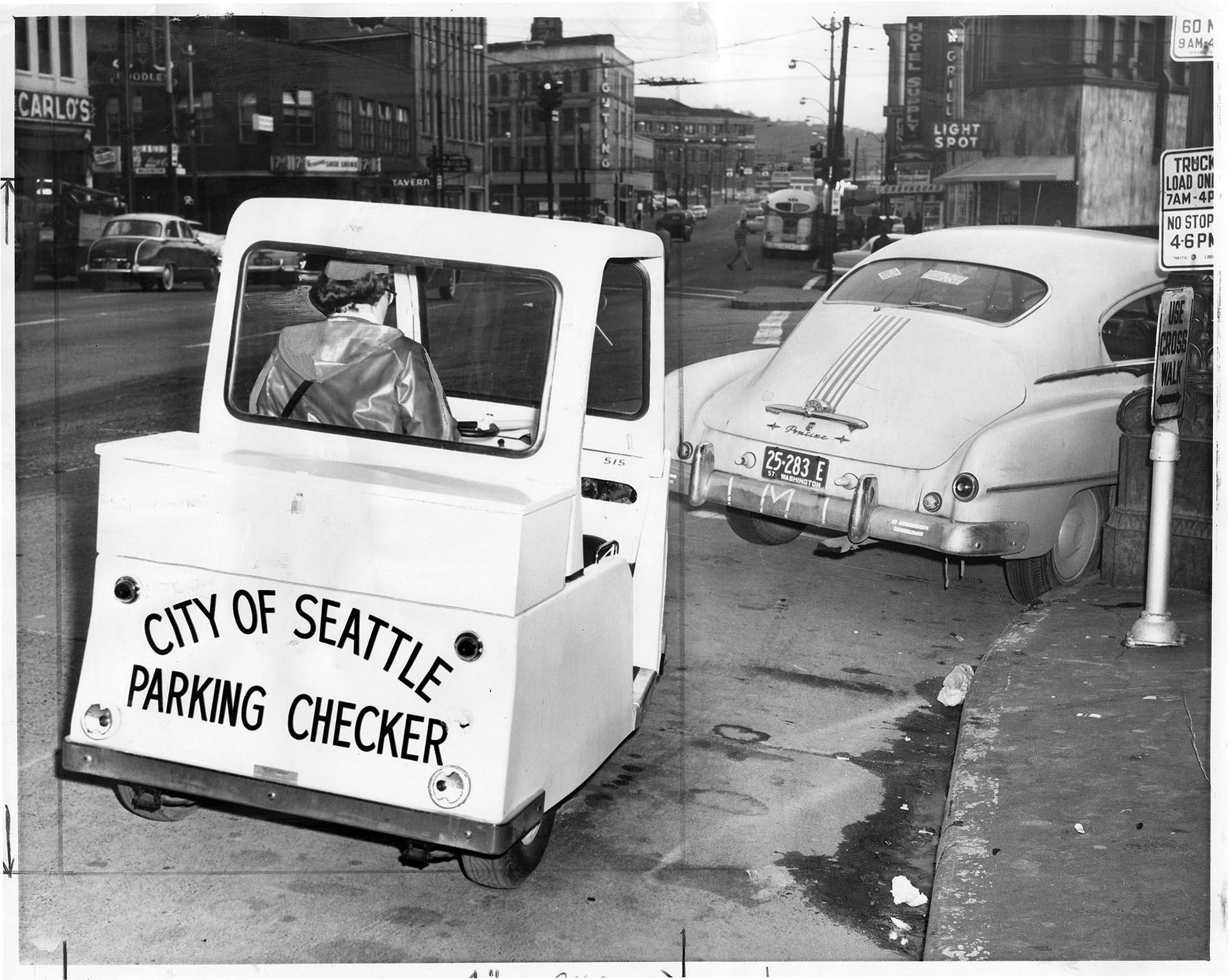 Image of Parking enforcement officer sitting in vehicle, Seattle, Seattle, January 22, 1958