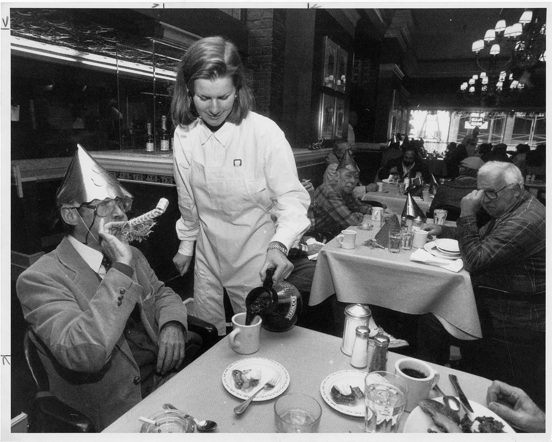 Image of Server pouring coffee for diner at F.X. McRory's, Seattle, December 30, 1990