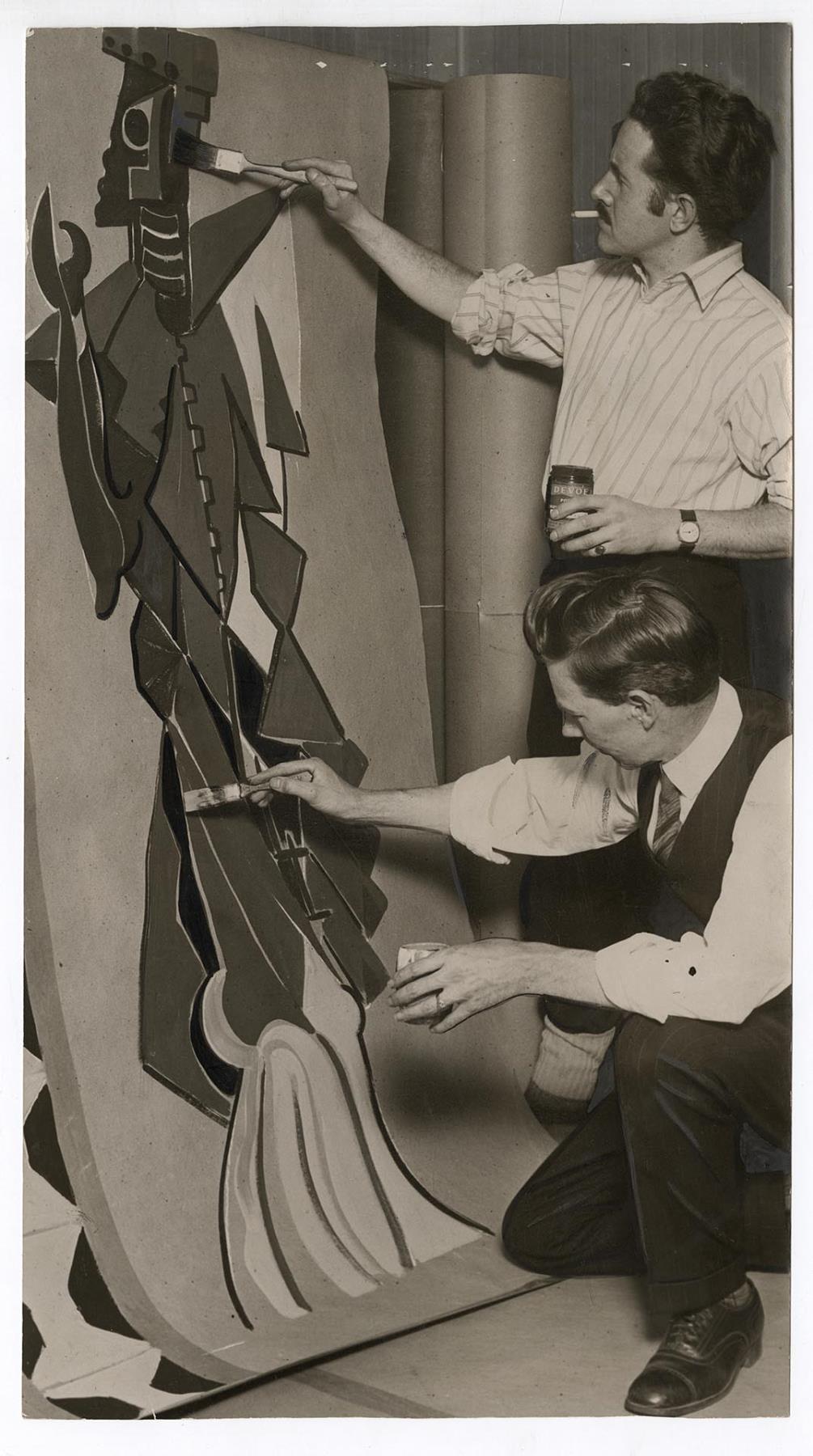 Image of Mark Tobey and Olaf Anderson painting a panel for the Mardi Gras ball, February 1928