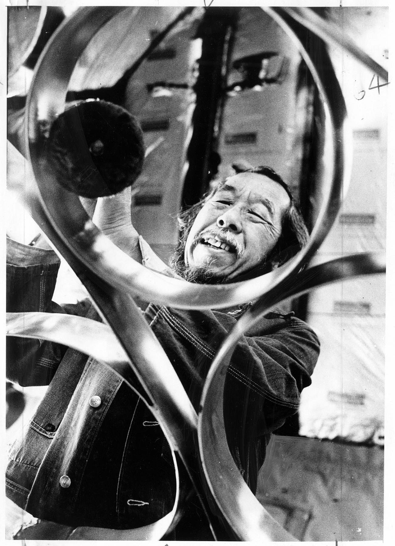 Image of George Tsutakawa polishing gates, Seattle, November 11, 1975