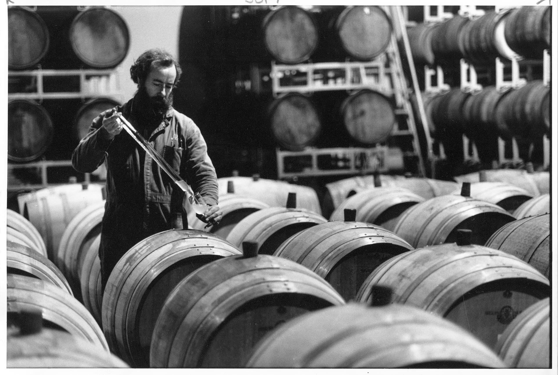 Image of Wine maker sampling from barrel, Woodinville, December 4, 1989
