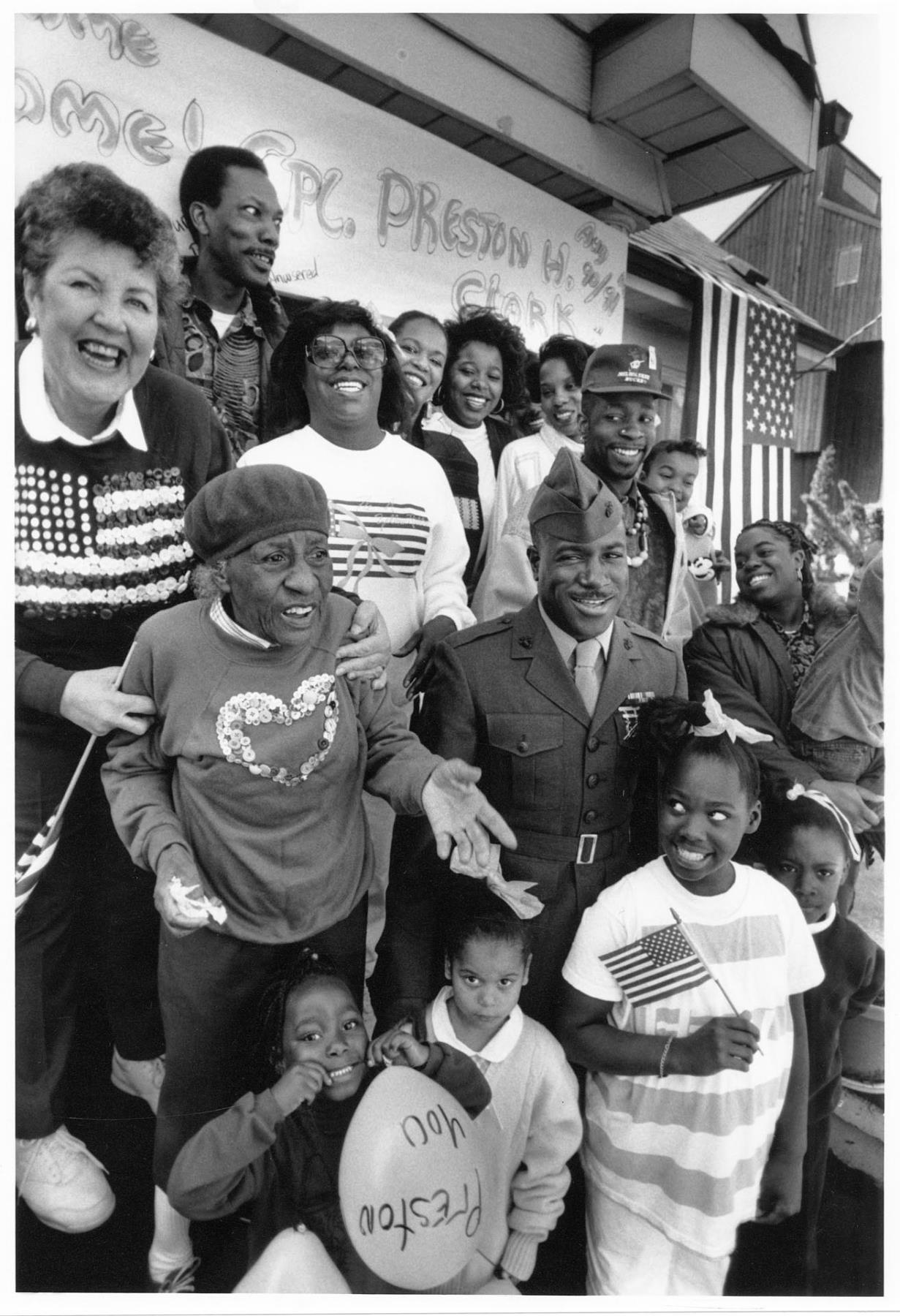 Image of Marine Cpl. Preston Clark with family and friends at his homecoming, Seattle, April 11, 1991
