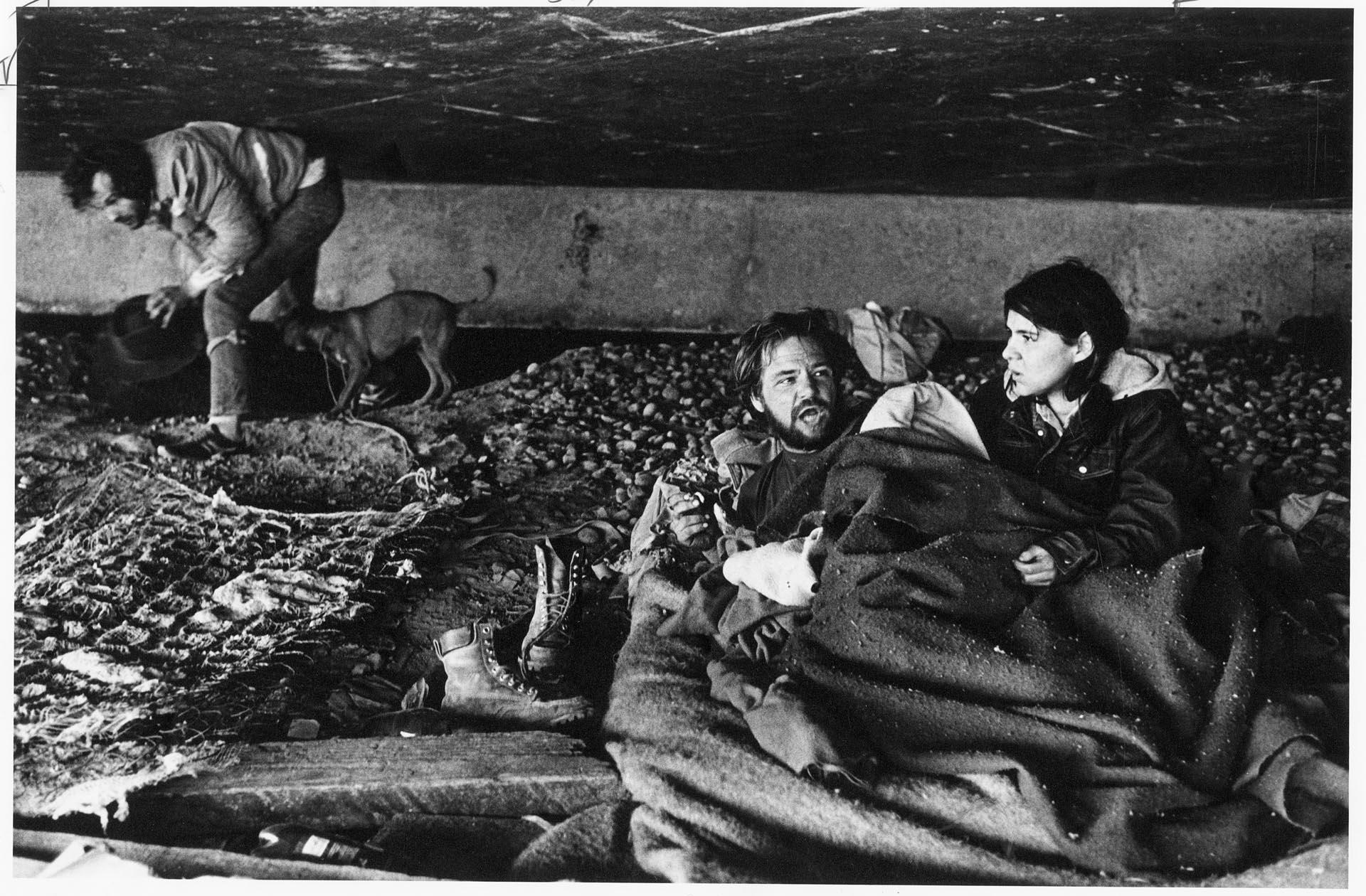 Image of Couple sitting under freeway overpass, Seattle, April 14, 1987
