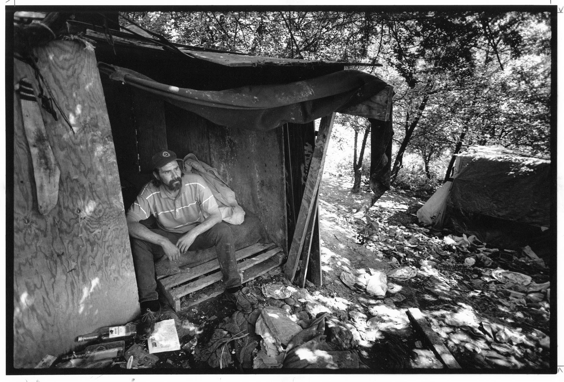 Image of Man sitting in temporary shelter, Seattle, May 1, 1991