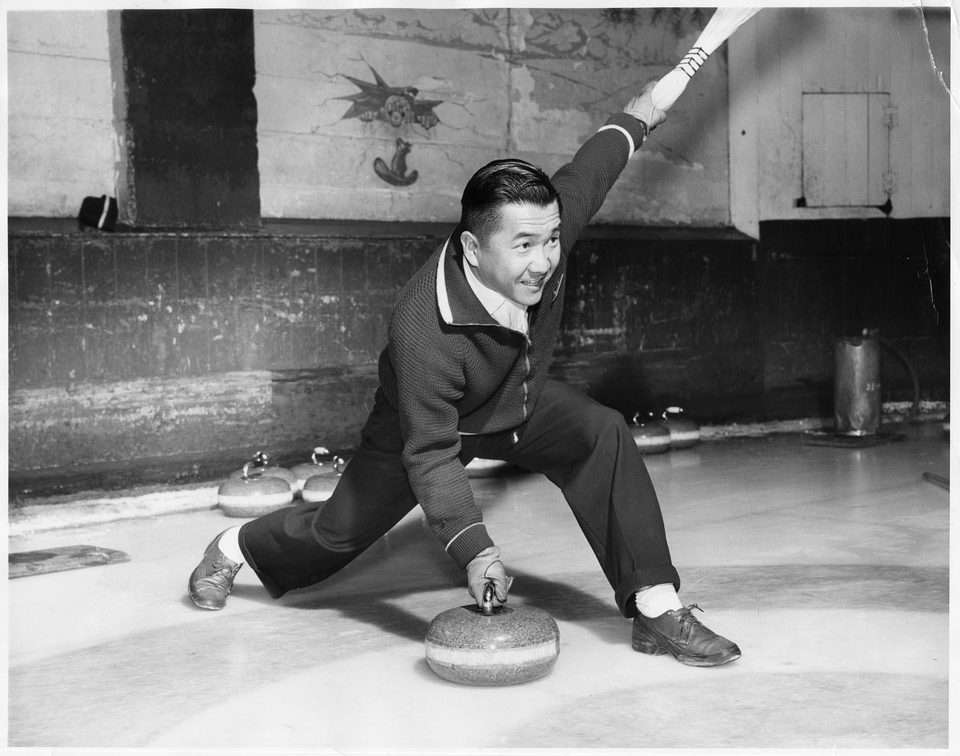 Image of Kearney Kozai with curling stone at the Granite Curling Club, Seattle, January 1960