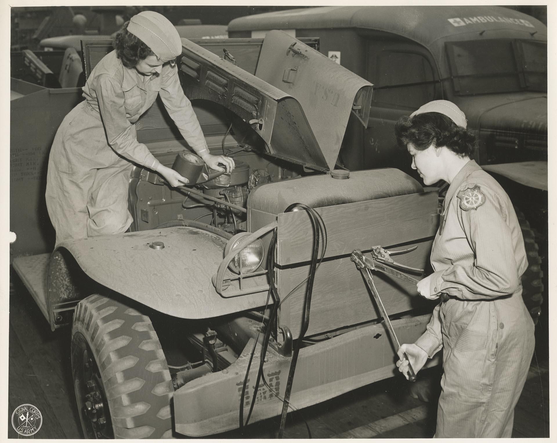 Image of Transportation Corps WACs fixing an Army Jeep, Seattle, July 1944