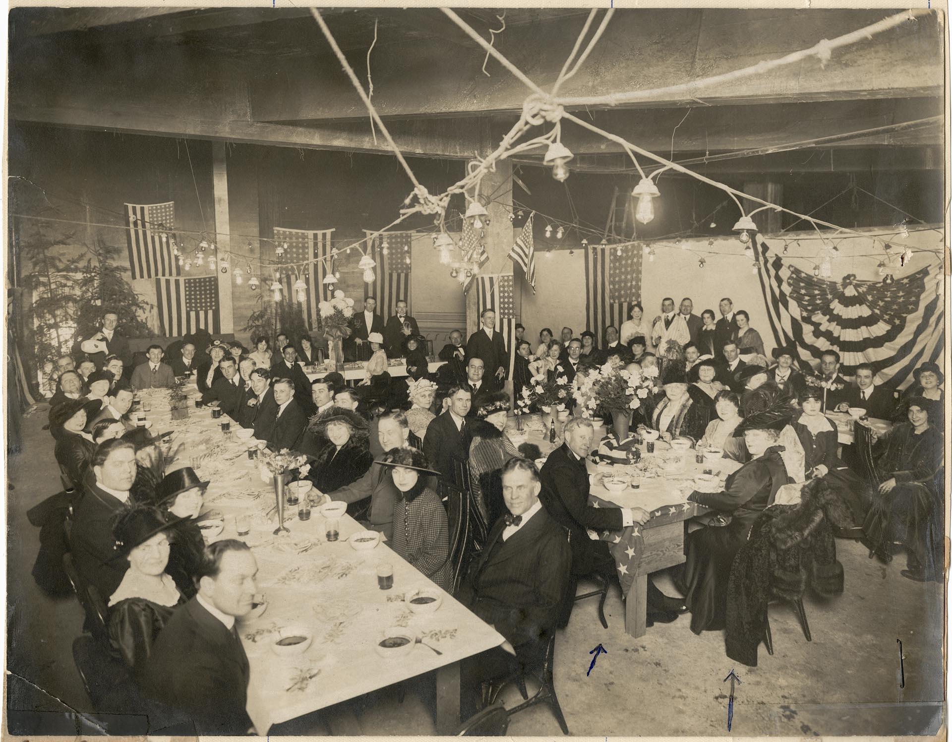 Image of Guests sitting at tables during chili party, Seattle, December 16, 1915