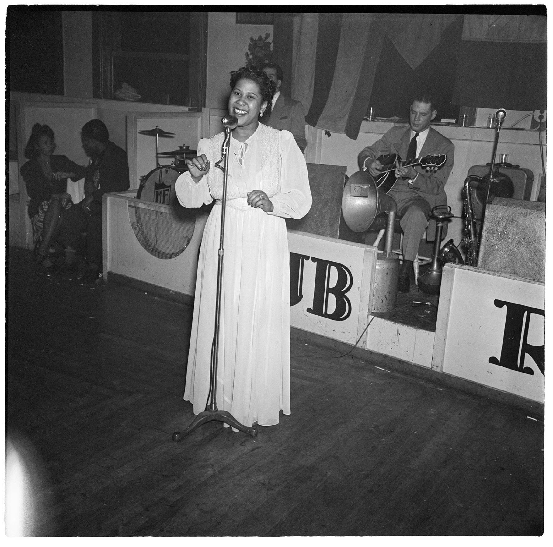 Image of Woman singing in front of a band at Club Rizal, Seattle, March 1, 1944