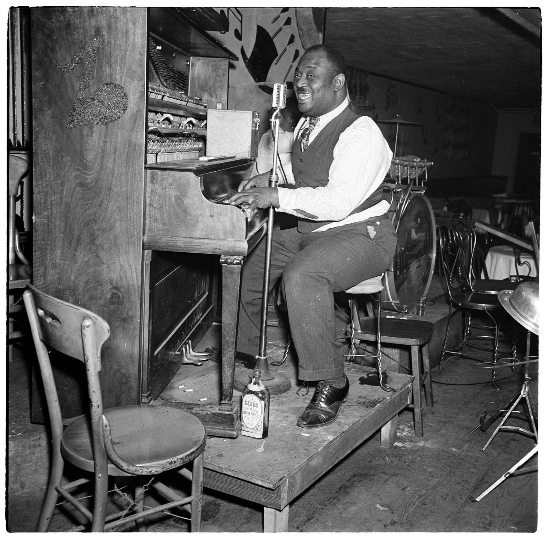 Image of Piano player singing on stage at the Black and Tan club, Seattle, November 11, 1944