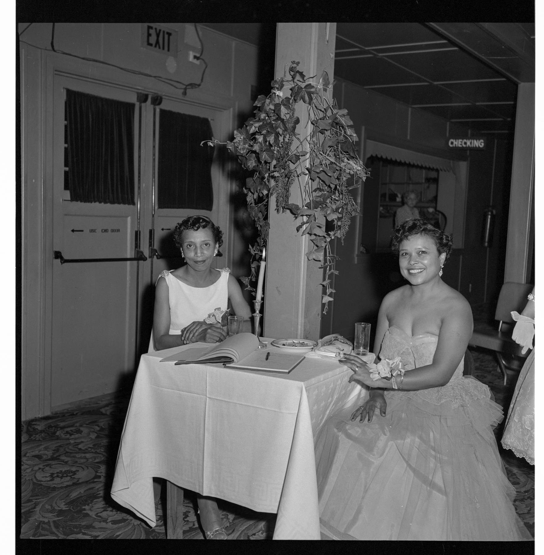 Image of Janice Fair and friend sitting at a table, Seattle, circa 1953