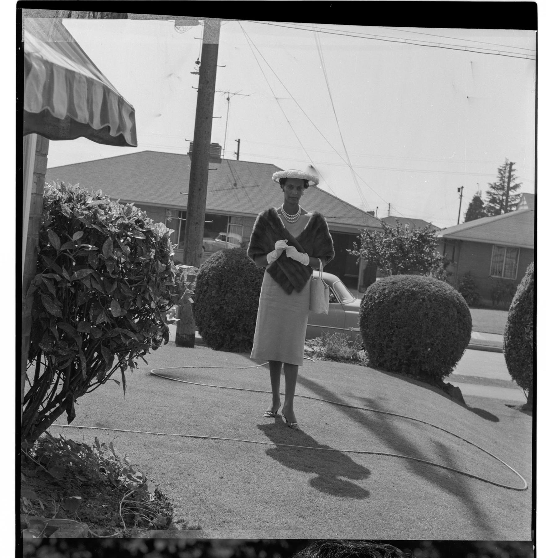 Image of Izzie Smith standing in her front yard, Seattle, circa 1953
