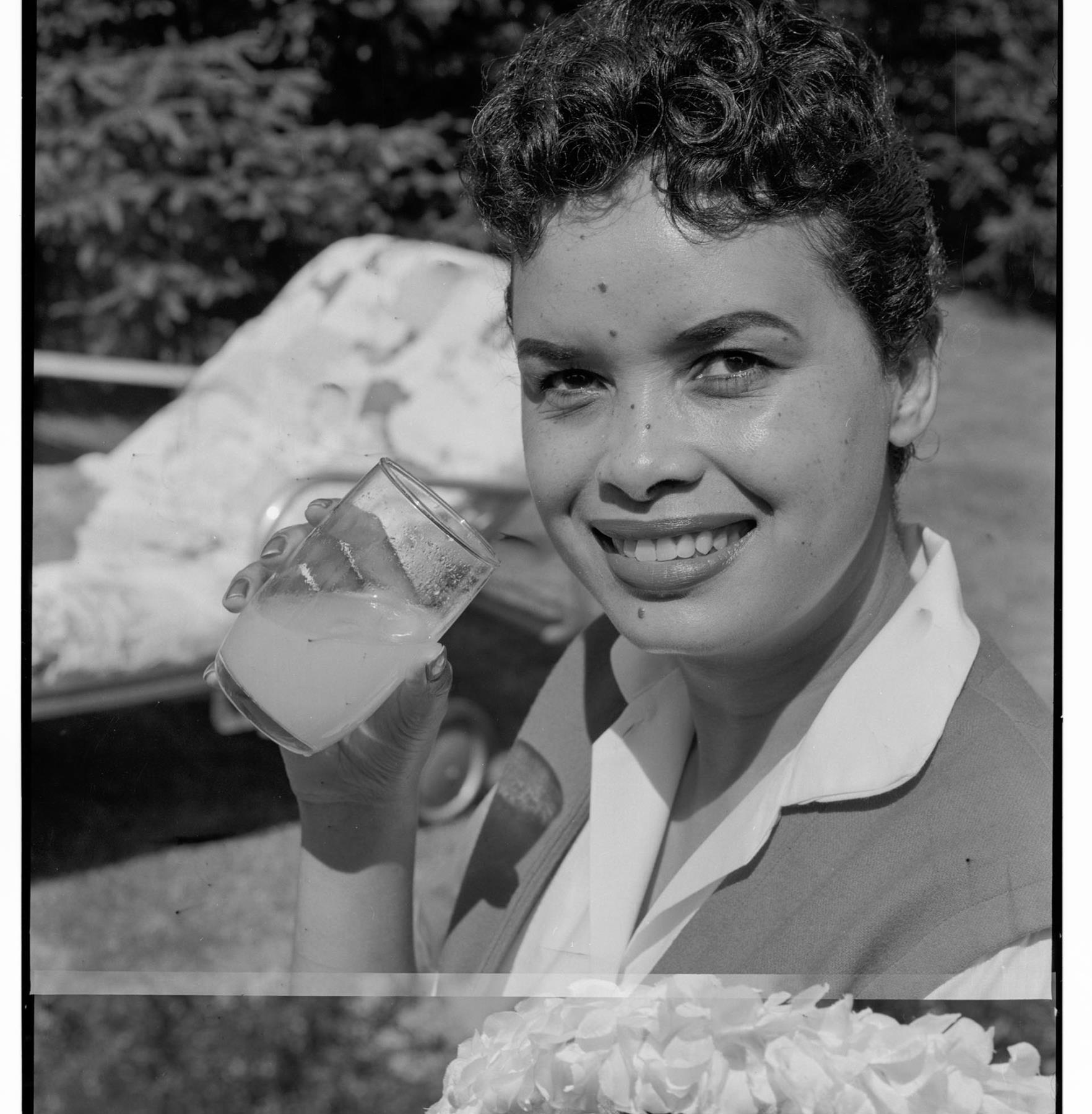 Image of Betty Connelly with drink in back yard, Seattle, circa 1953