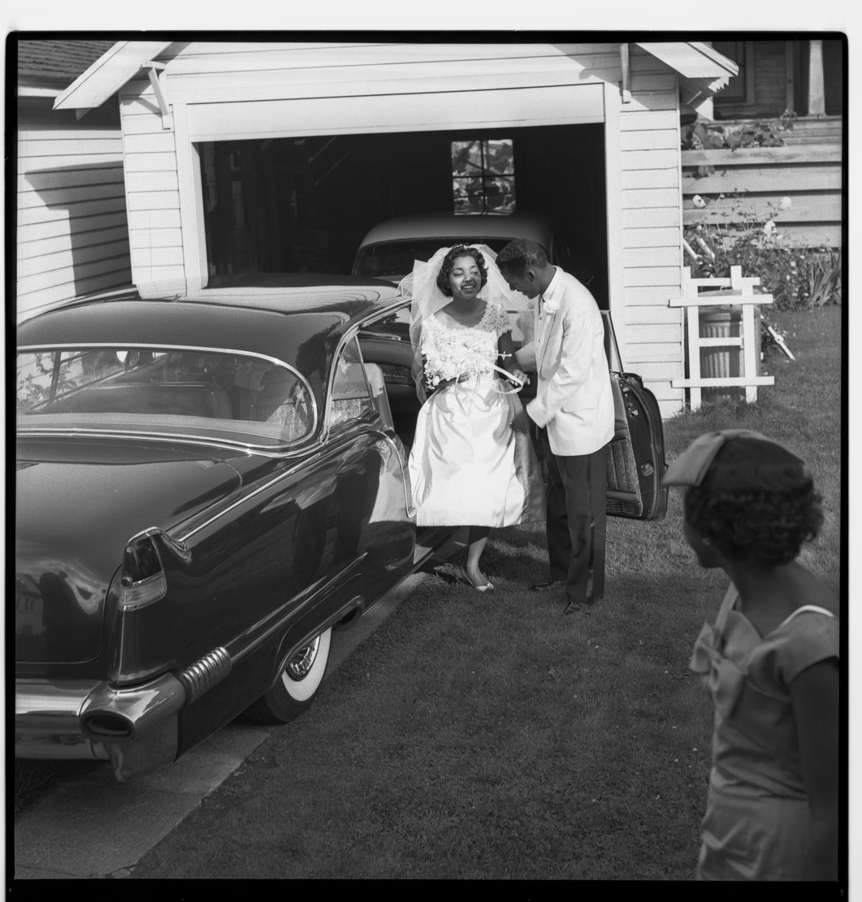 Image of Bride and groom exiting car, Seattle, September 27, 1959