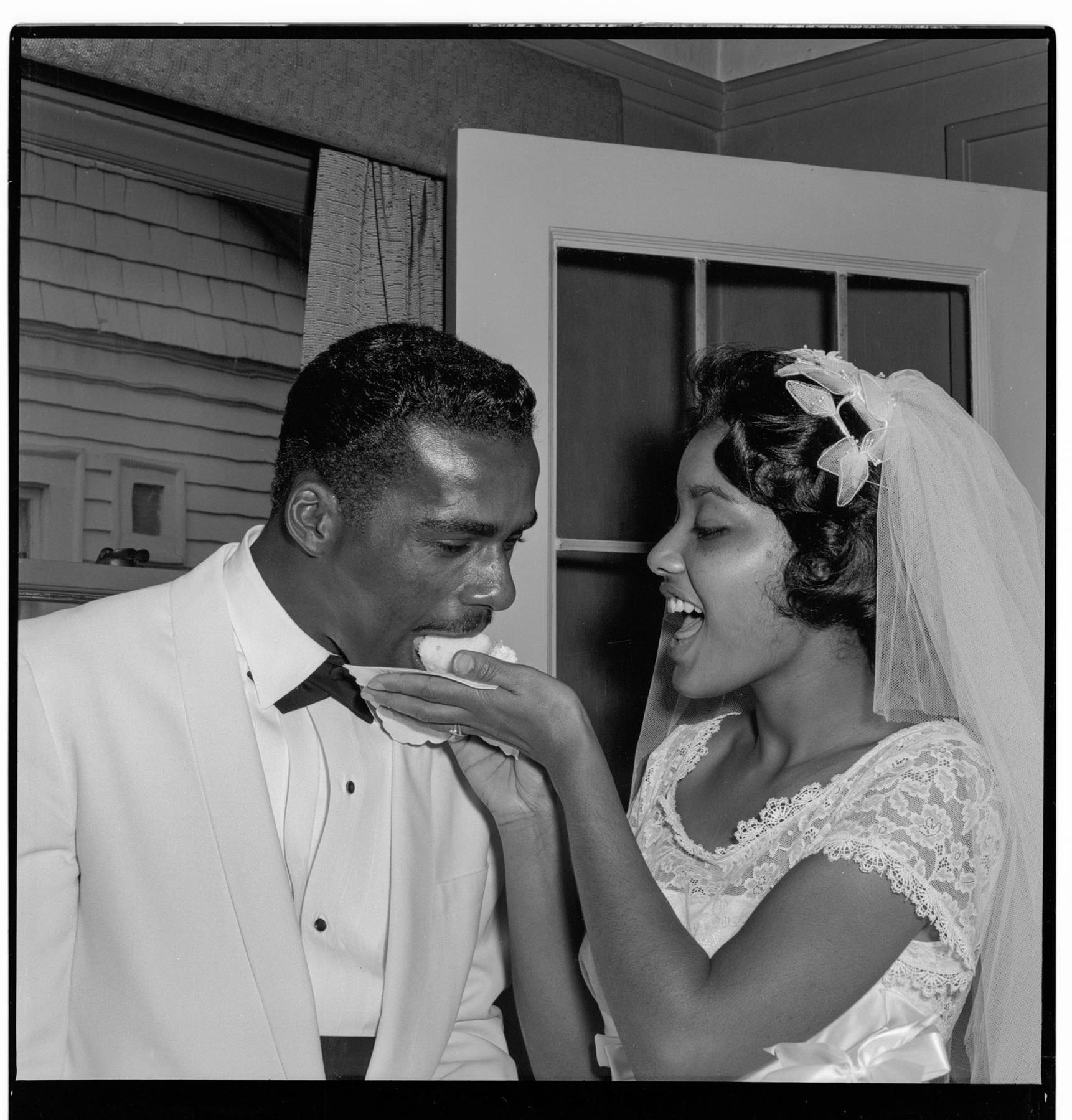 Image of Bride and groom eating cake, Seattle, September  27, 1959