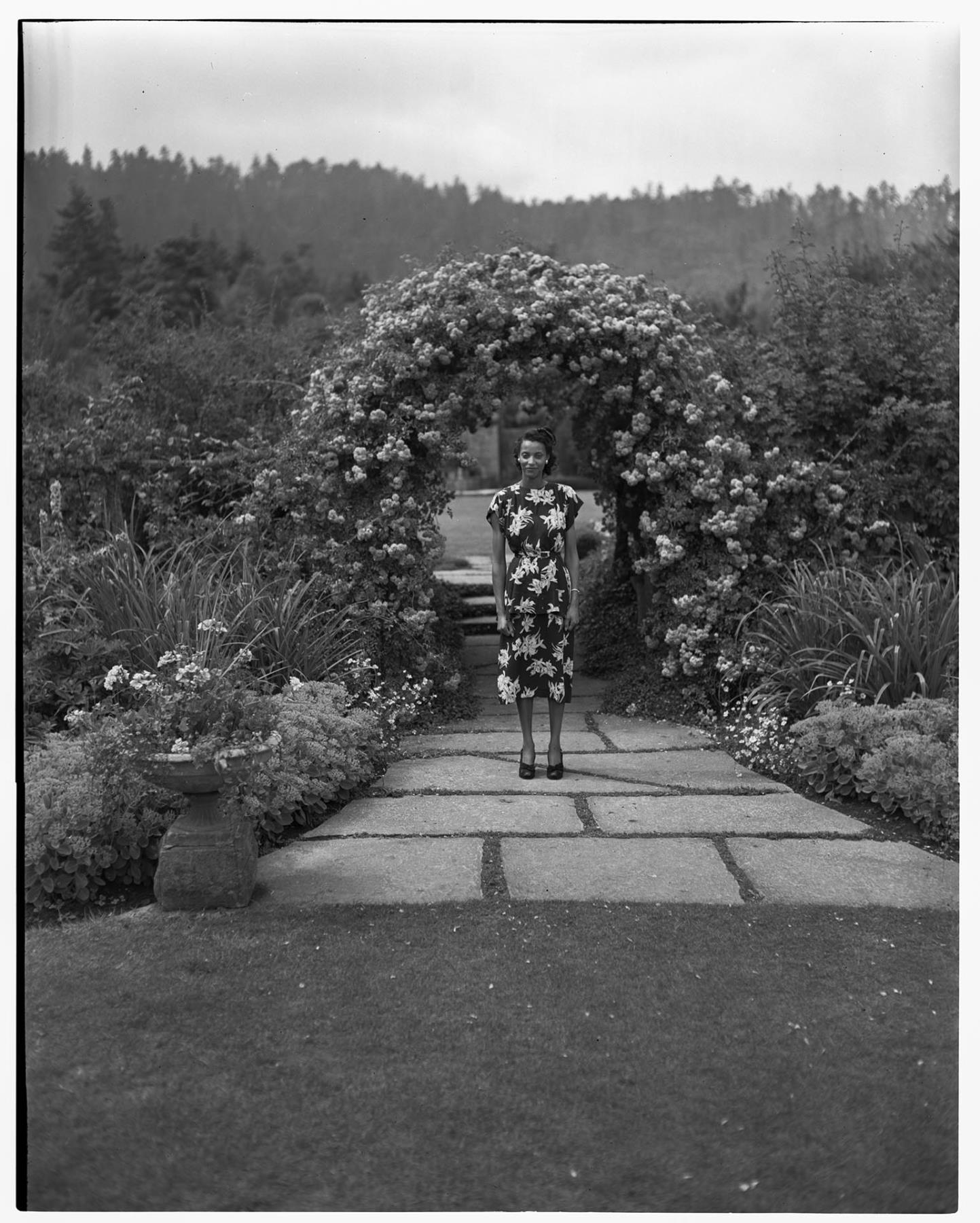 Image of Izzy Smith posing in a garden, Victoria, BC, July 26, 1948