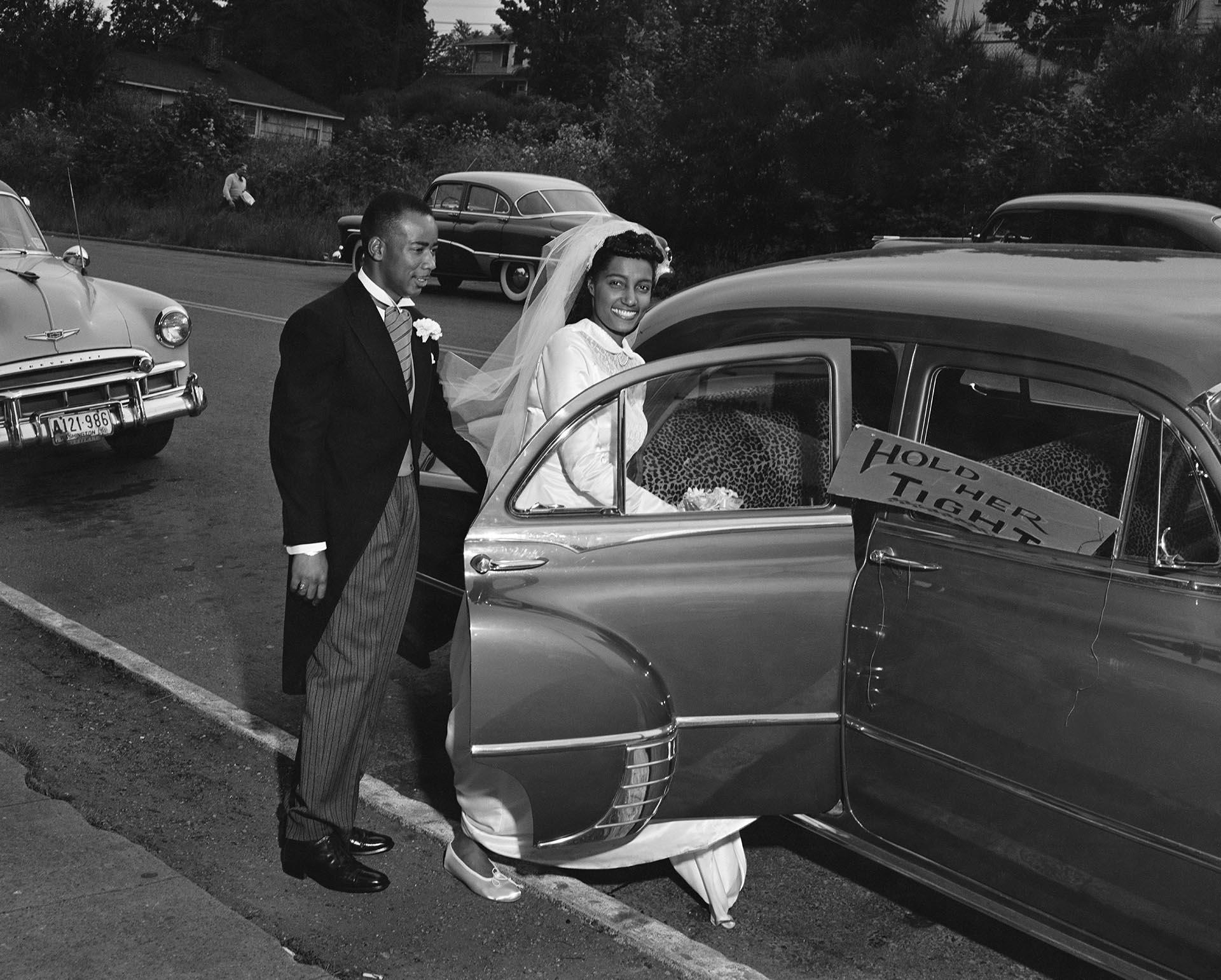 Image of Deloris and Rhone Berry entering car on their wedding day, Seattle, June 15, 1952