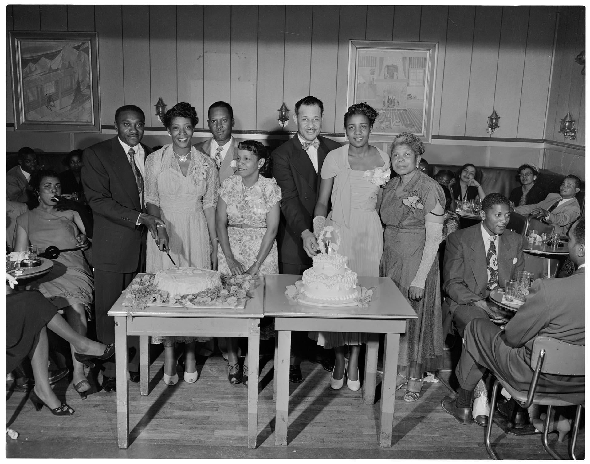 Image of Newlyweds cutting cake at a double wedding, Seattle, circa 1950