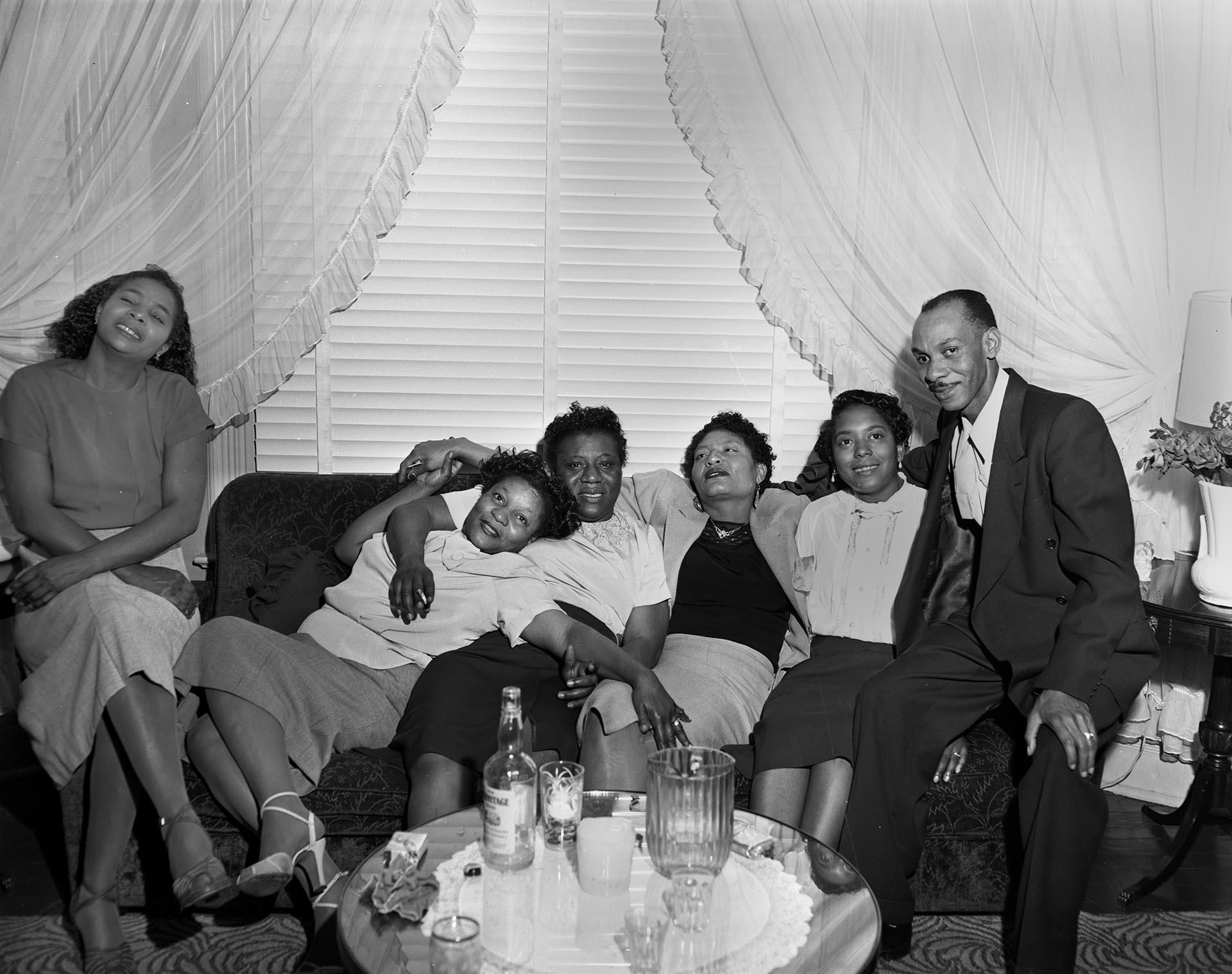 Image of Party-goers sitting on a couch, Seattle, circa 1945