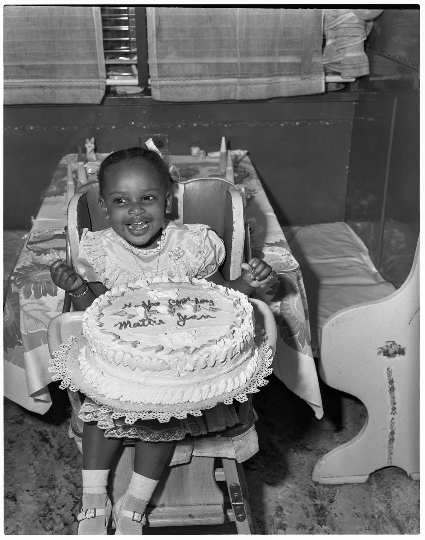 Image of Girl in high chair with birthday cake, Seattle, circa 1955