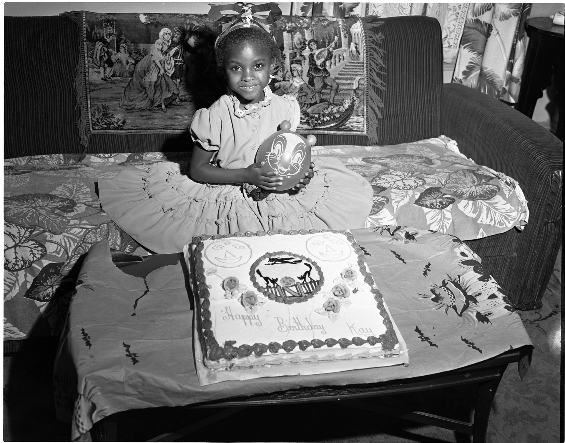 Image of Birthday girl posing with cake, Seattle, circa 1953