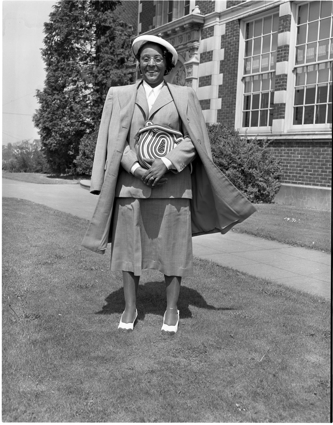 Image of Mrs. Harrison standing outside Garfield High School, Seattle,  May 7, 1950<br />