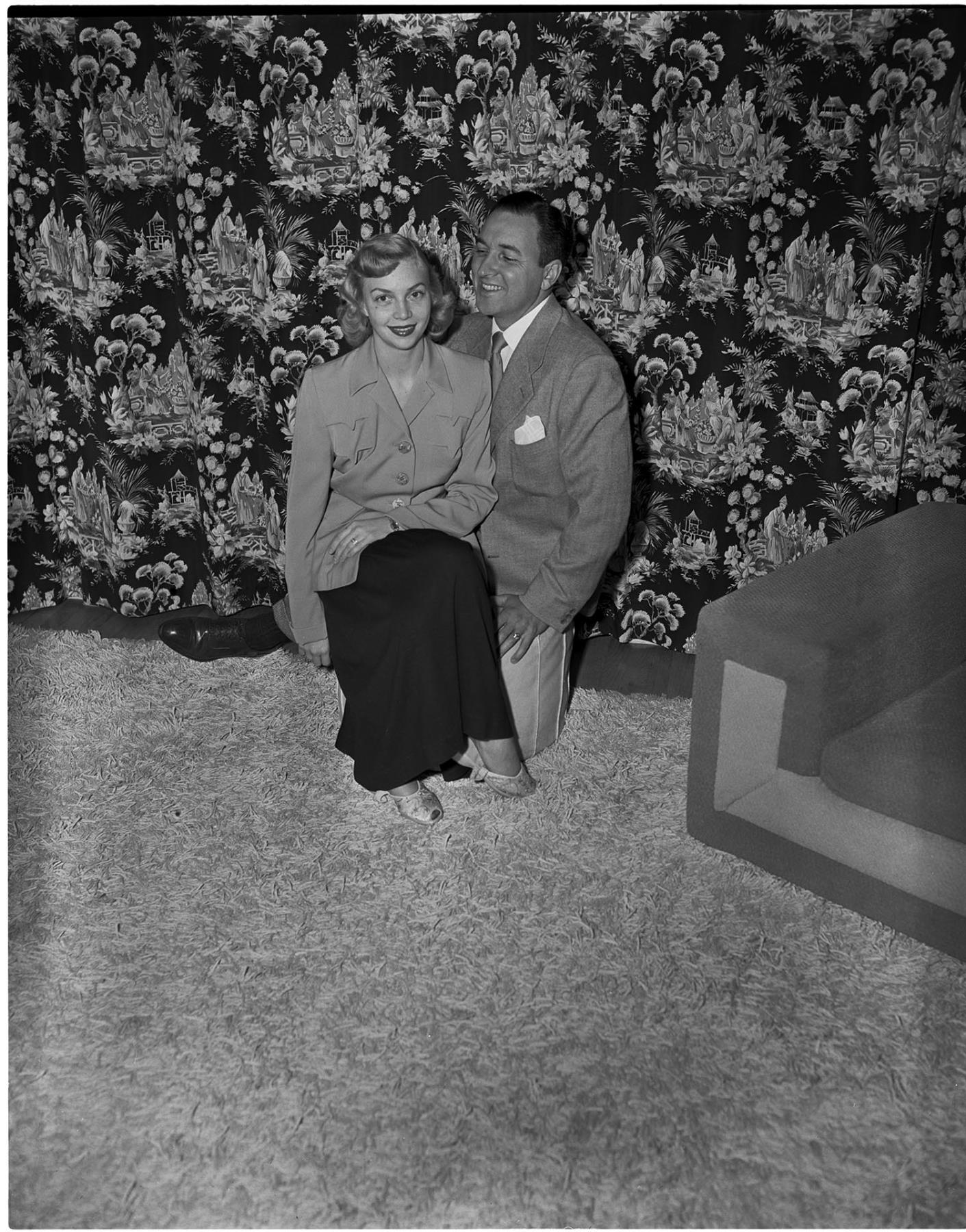 Image of Italian club president and wife seated on stool, Seattle, circa 1950