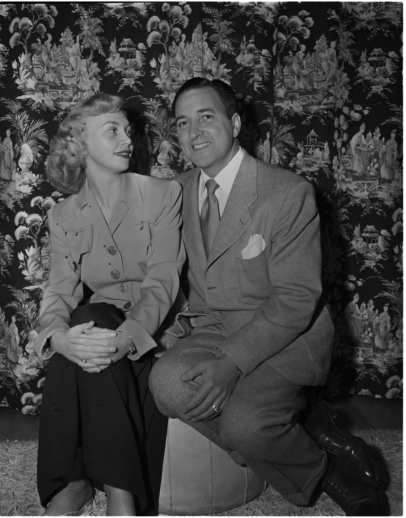 Image of Italian club president and wife seated on stool, Seattle, circa 1950