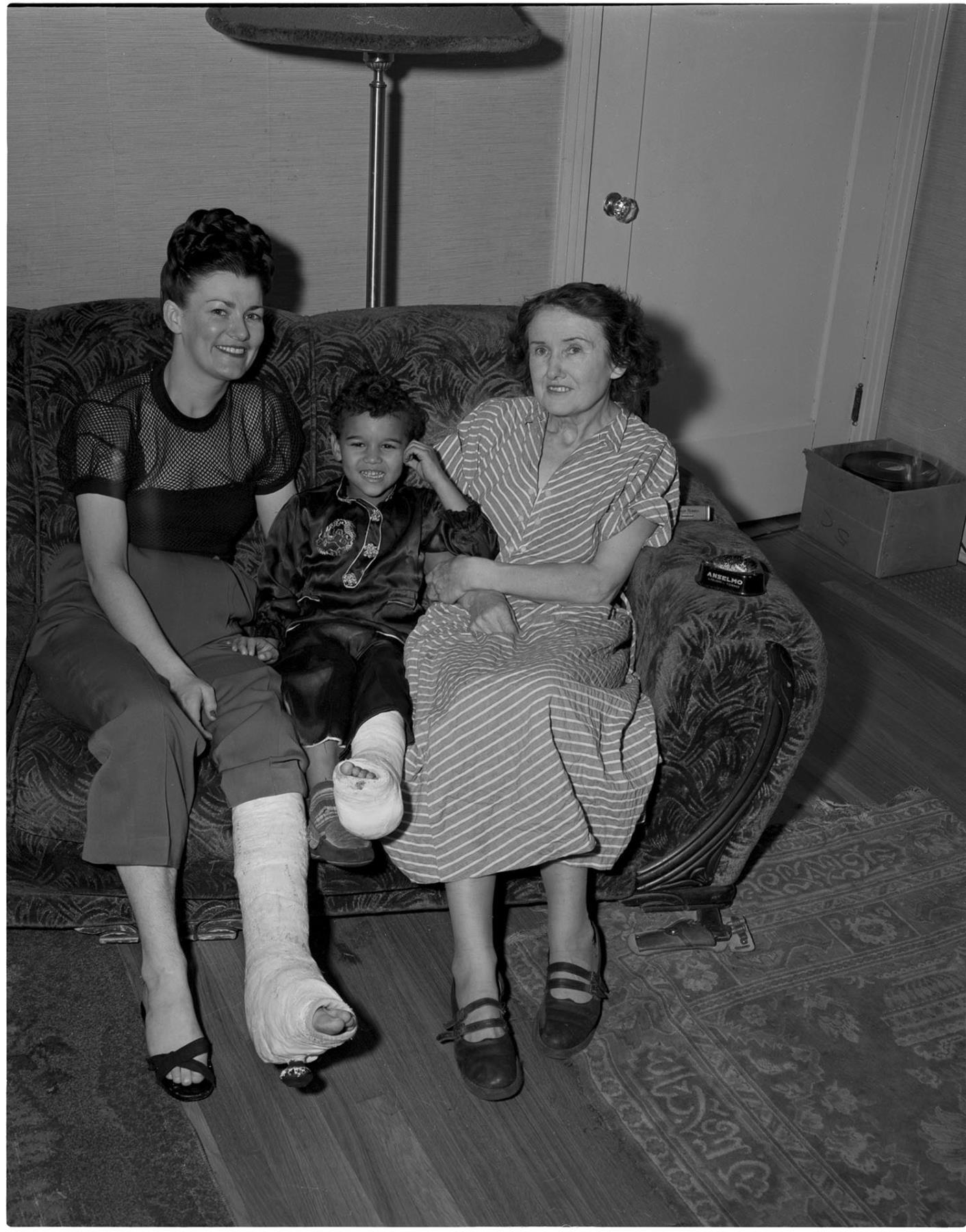 Image of Two women and boy sitting on couch, Seattle, circa 1953
