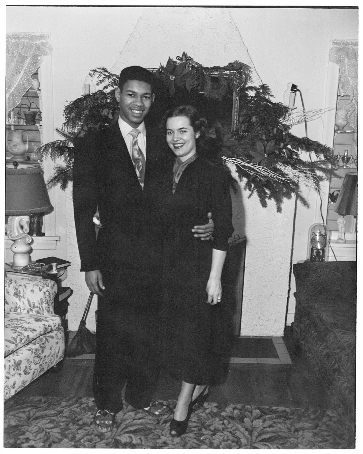 Image of Charlie Taylor and wife standing in living room, Seattle, circa 1953