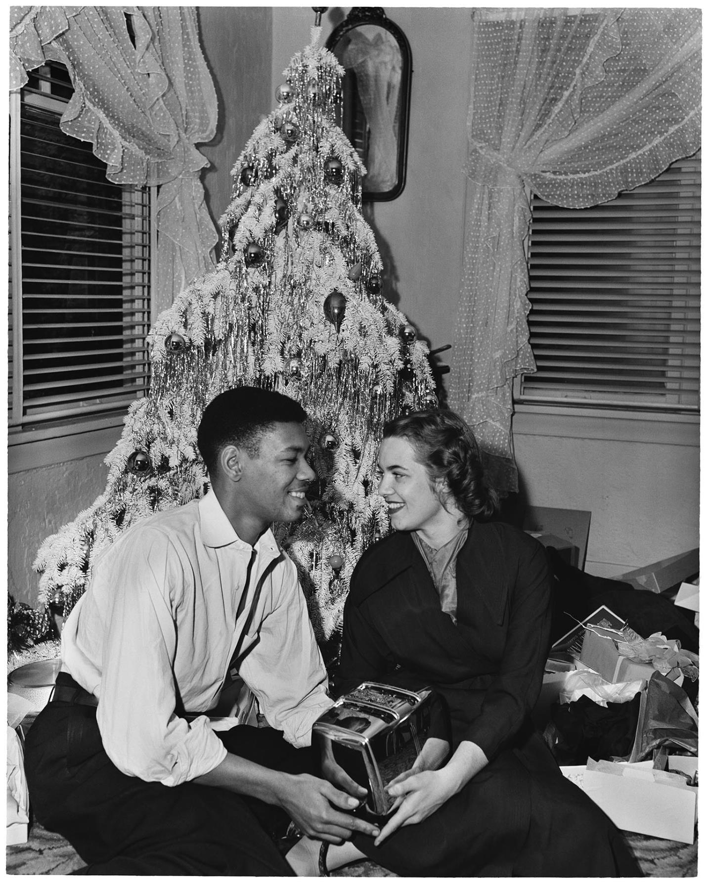 Image of Charlie Taylor and wife sitting in front of Christmas tree, Seattle, circa 1953