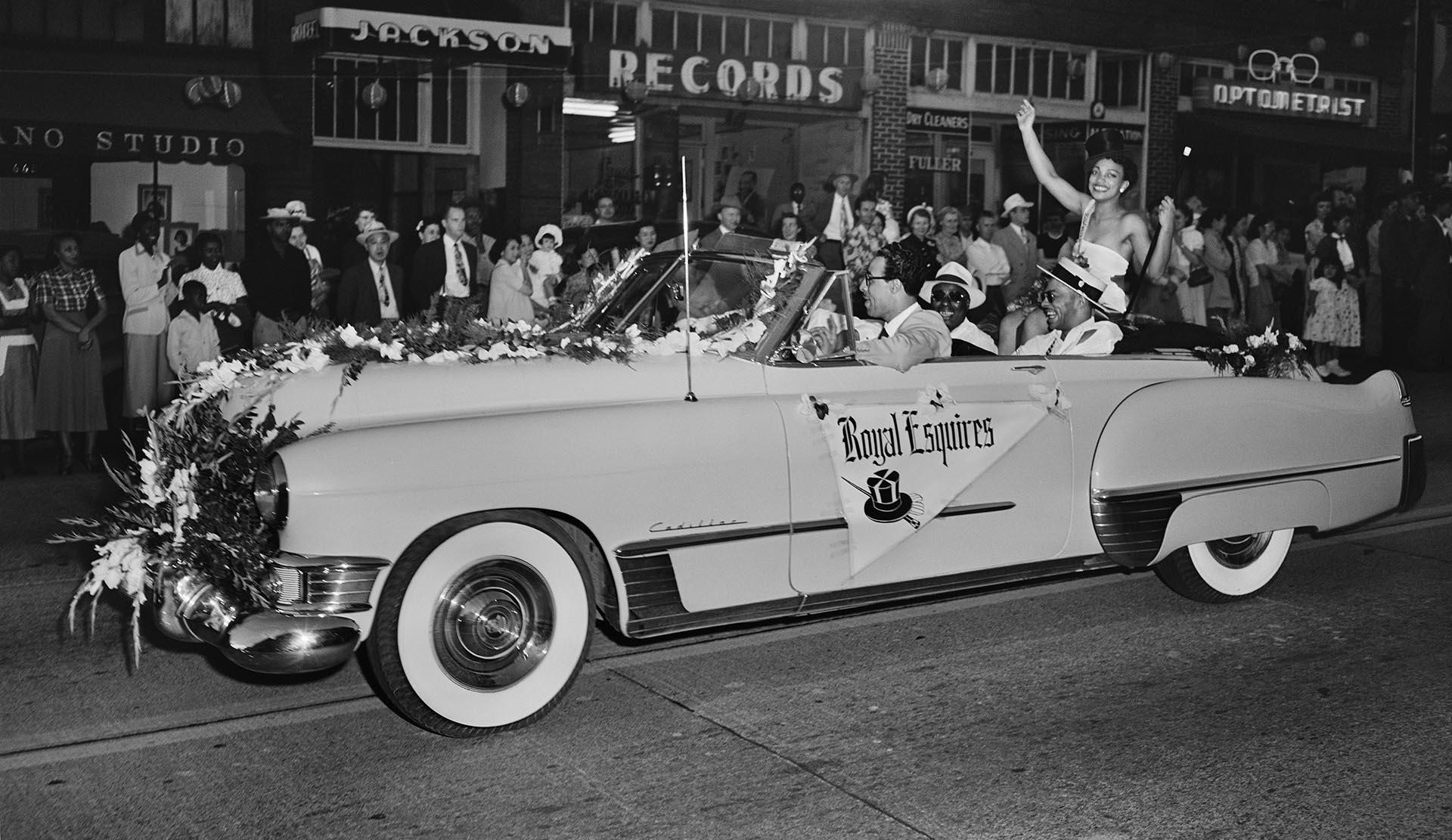 Image of Festival queen waving from car during parade, Seattle, circa 1950