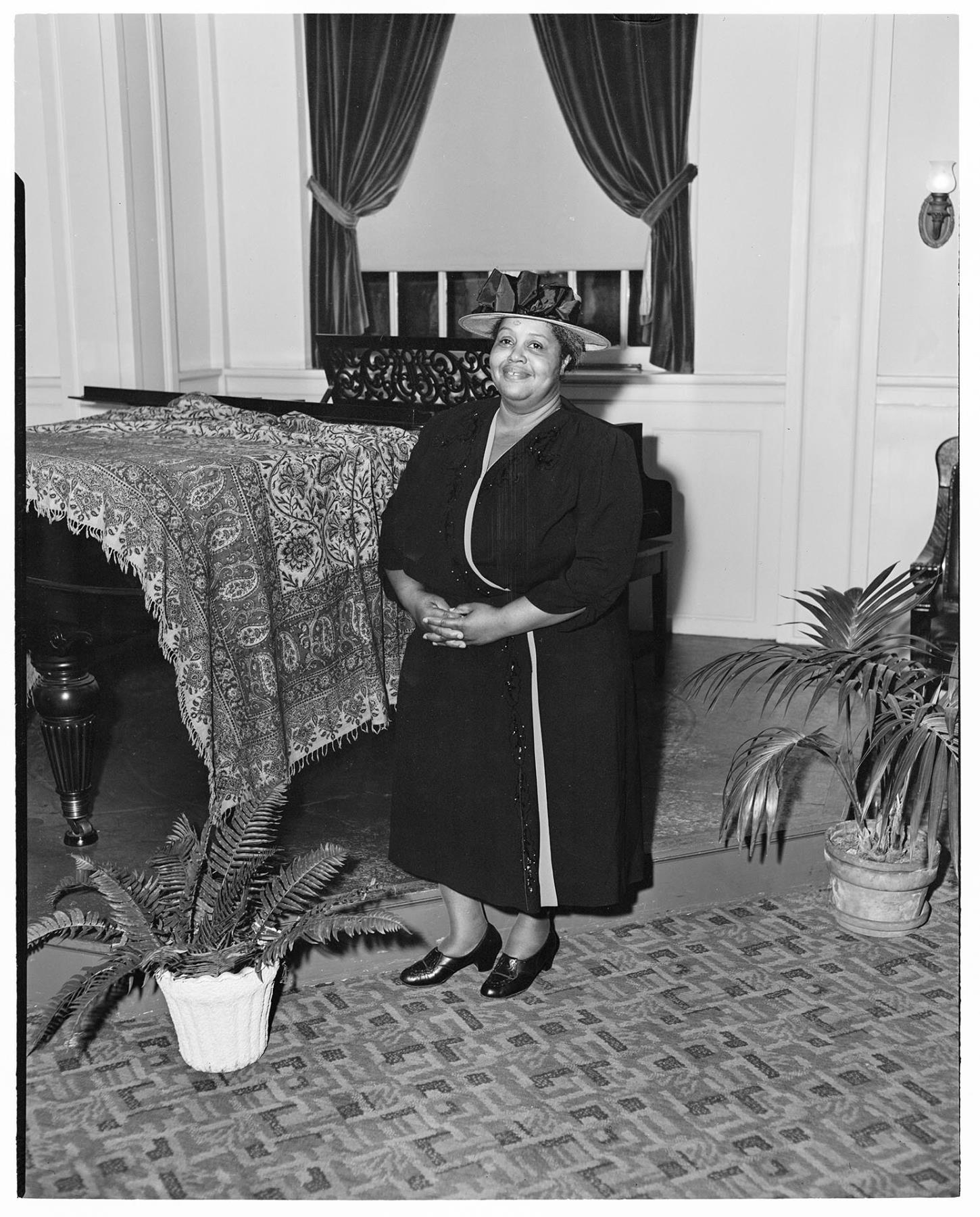 Image of Woman posing near piano, Seattle, circa 1953