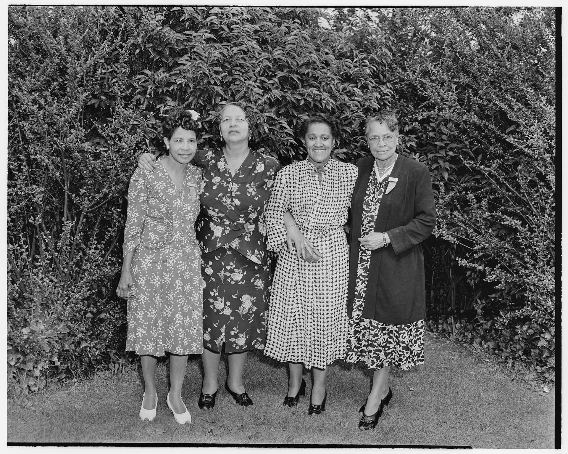 Image of Four NACWC convention delegates posing outdoors, Seattle, August 1948