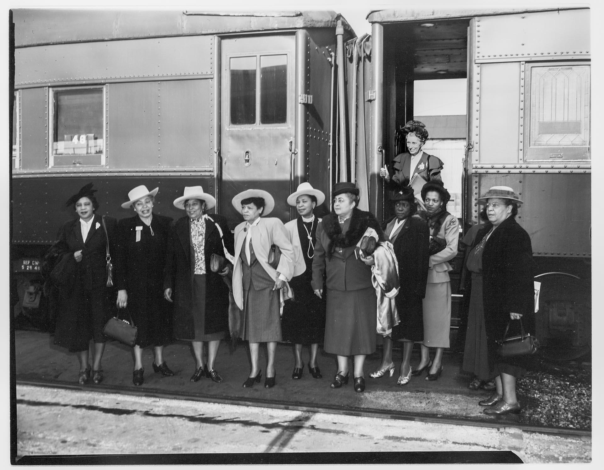 Image of NACWC convention delegates near train at King Street Station, Seattle, August 1948